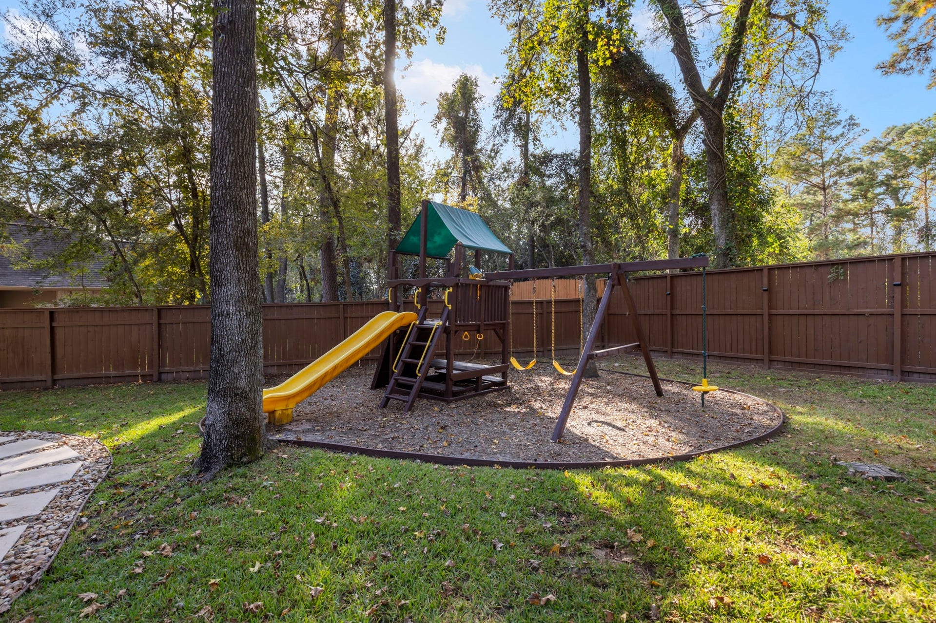 90 W Horizon Ridge Place, Spring, TX 77381 This backyard escape features newly refurbished kids' play equipment, making it a delightful space for everyone to enjoy!