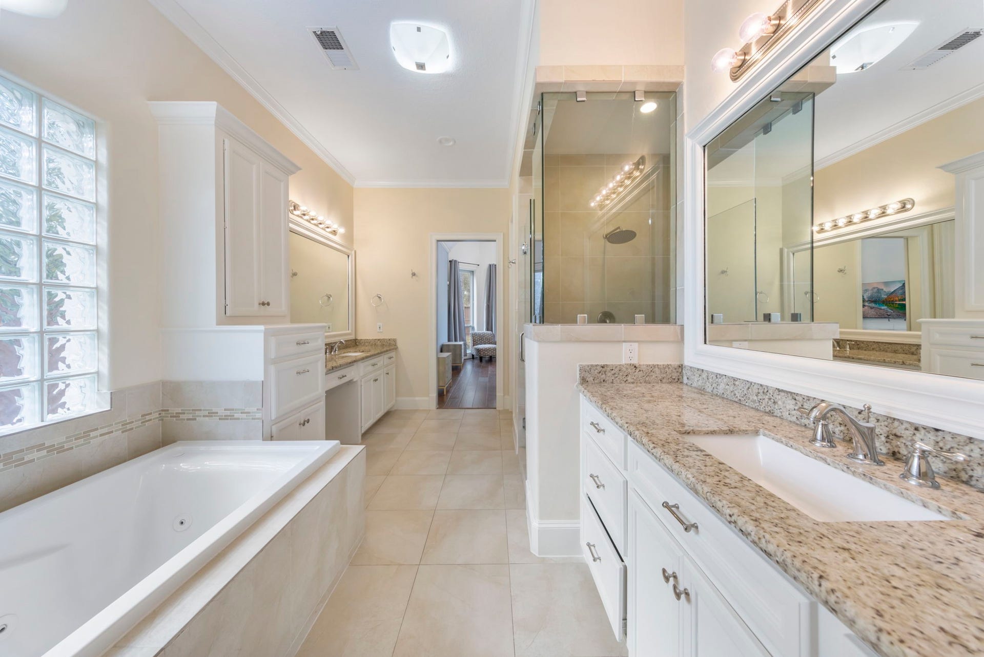 90 W Horizon Ridge Place, Spring, TX 77381 The primary bath provides a spacious retreat, featuring an oversized walk-in shower, a luxurious soaking tub, and dual sinks with a convenient vanity seating area.