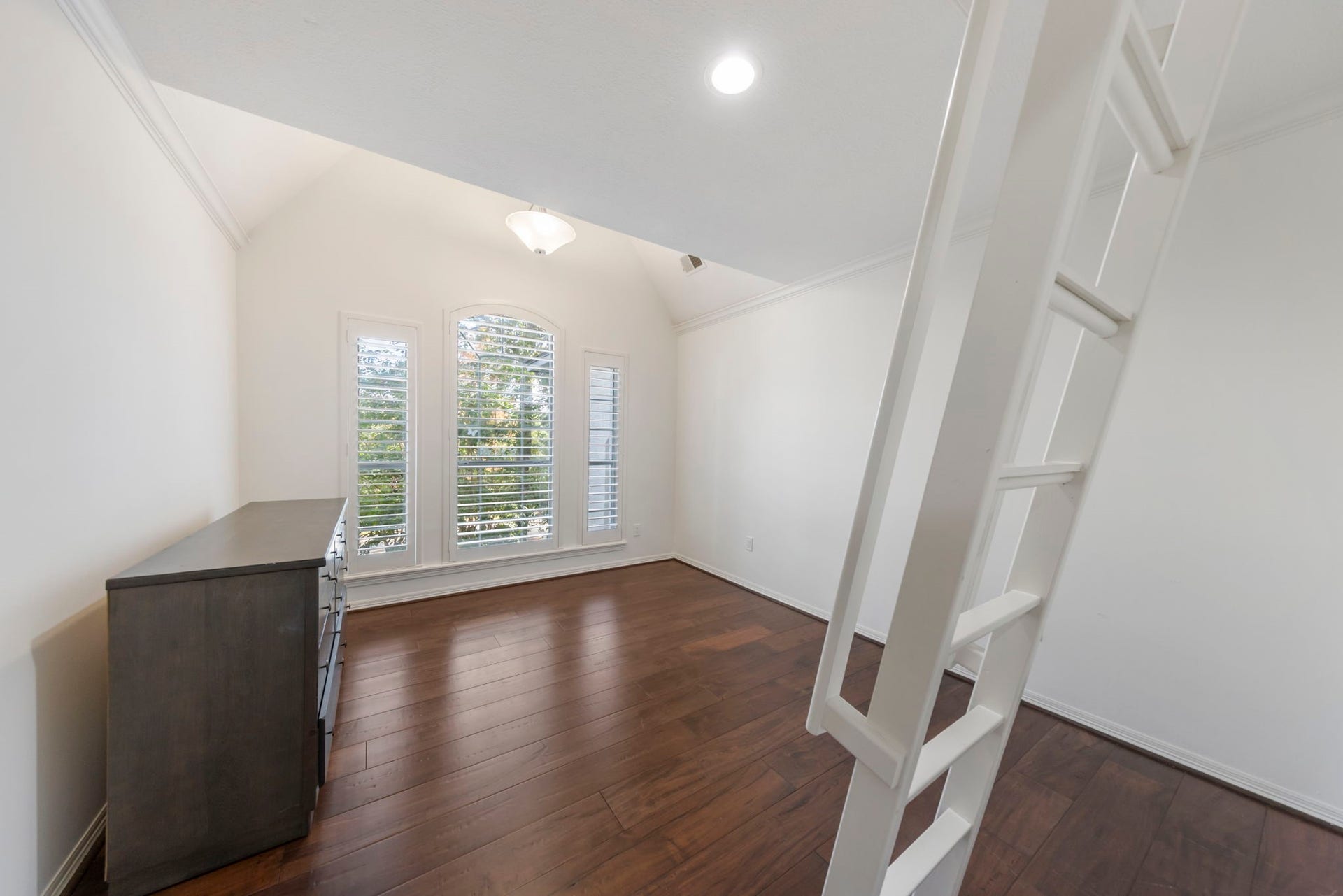 90 W Horizon Ridge Place, Spring, TX 77381 This additional upstairs bedroom features a high A-frame ceiling and a charming loft with ladder access, perfect for a cozy reading nook or a kids' hideaway!