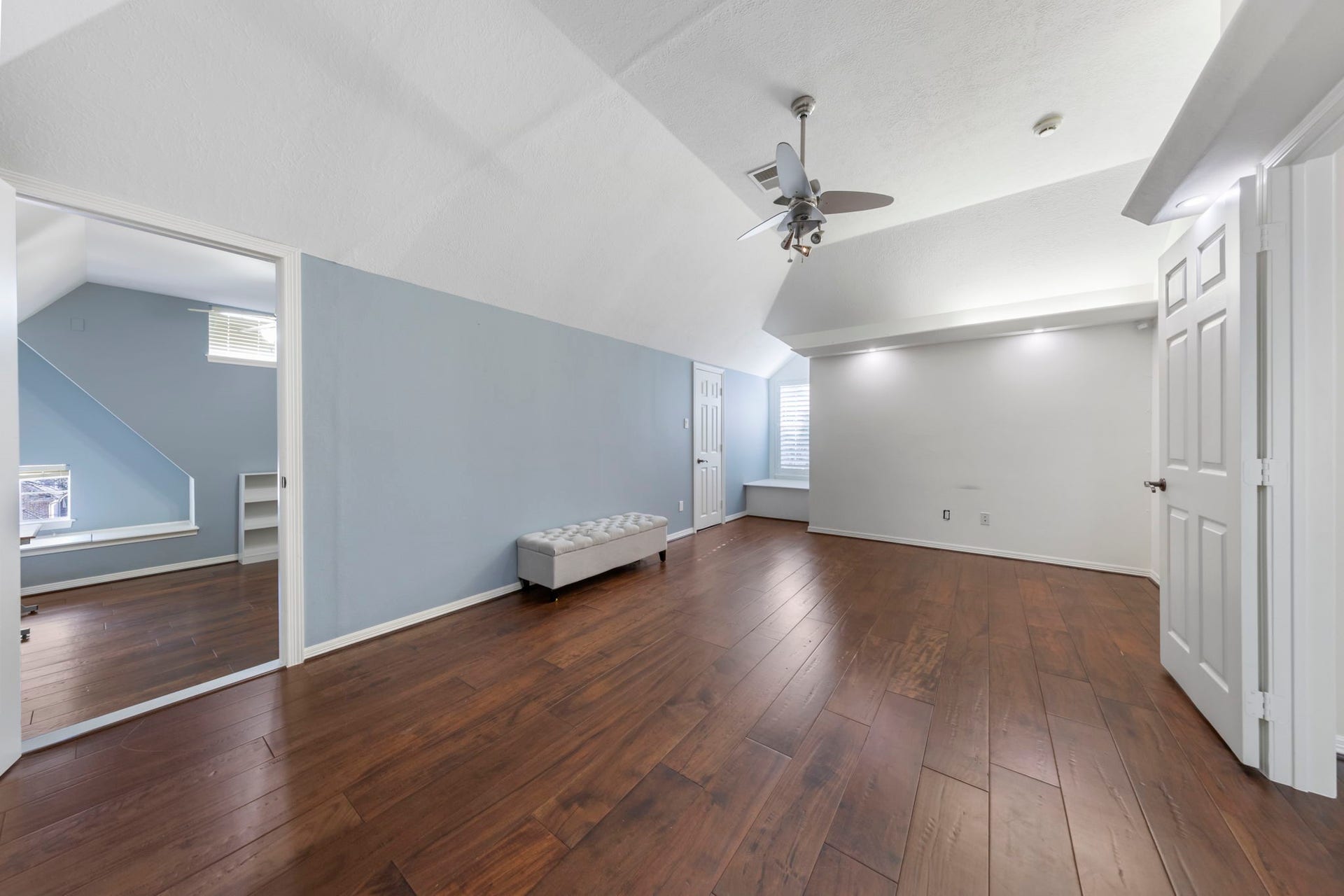 90 W Horizon Ridge Place, Spring, TX 77381 The largest upstairs bedroom showcases wood floors, vaulted ceilings, a cozy window nook, built-in shelves, and an attached hidden room!