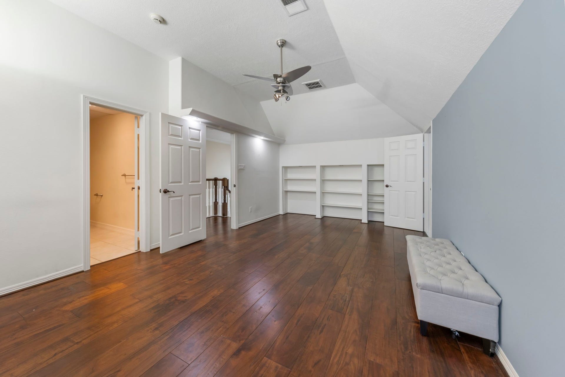 90 W Horizon Ridge Place, Spring, TX 77381 View of spacious upstairs bedroom features ensuite bath, built-in shelves, and access to hidden room!