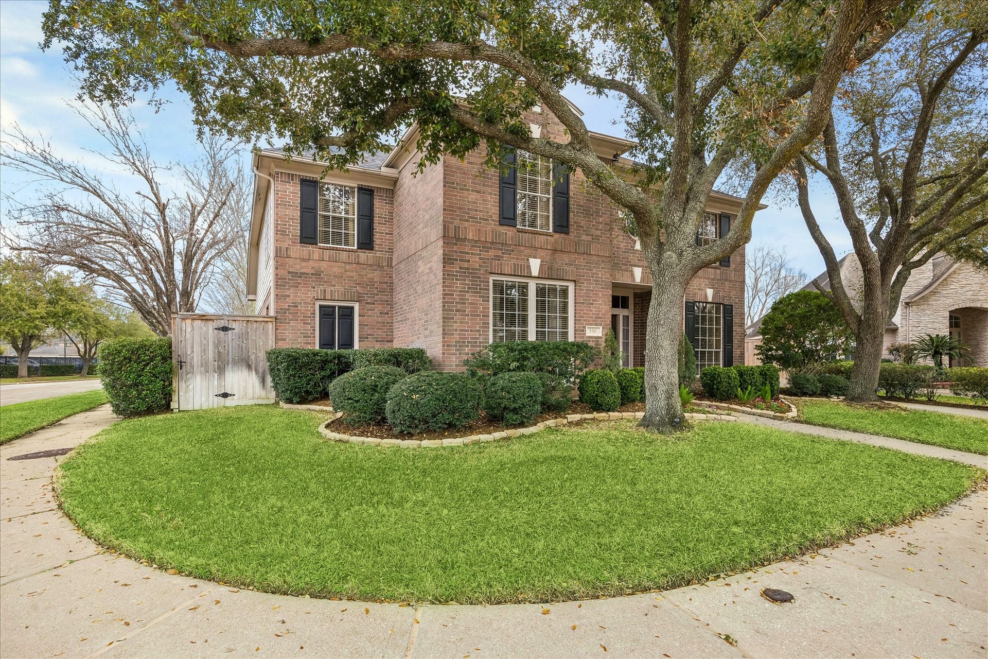 5310 Summerland Ridge Court, Houston, TX 77041 The house features black shutters, large windows, and a welcoming entrance. Located on a corner lot, it offers a spacious and inviting curb appeal.