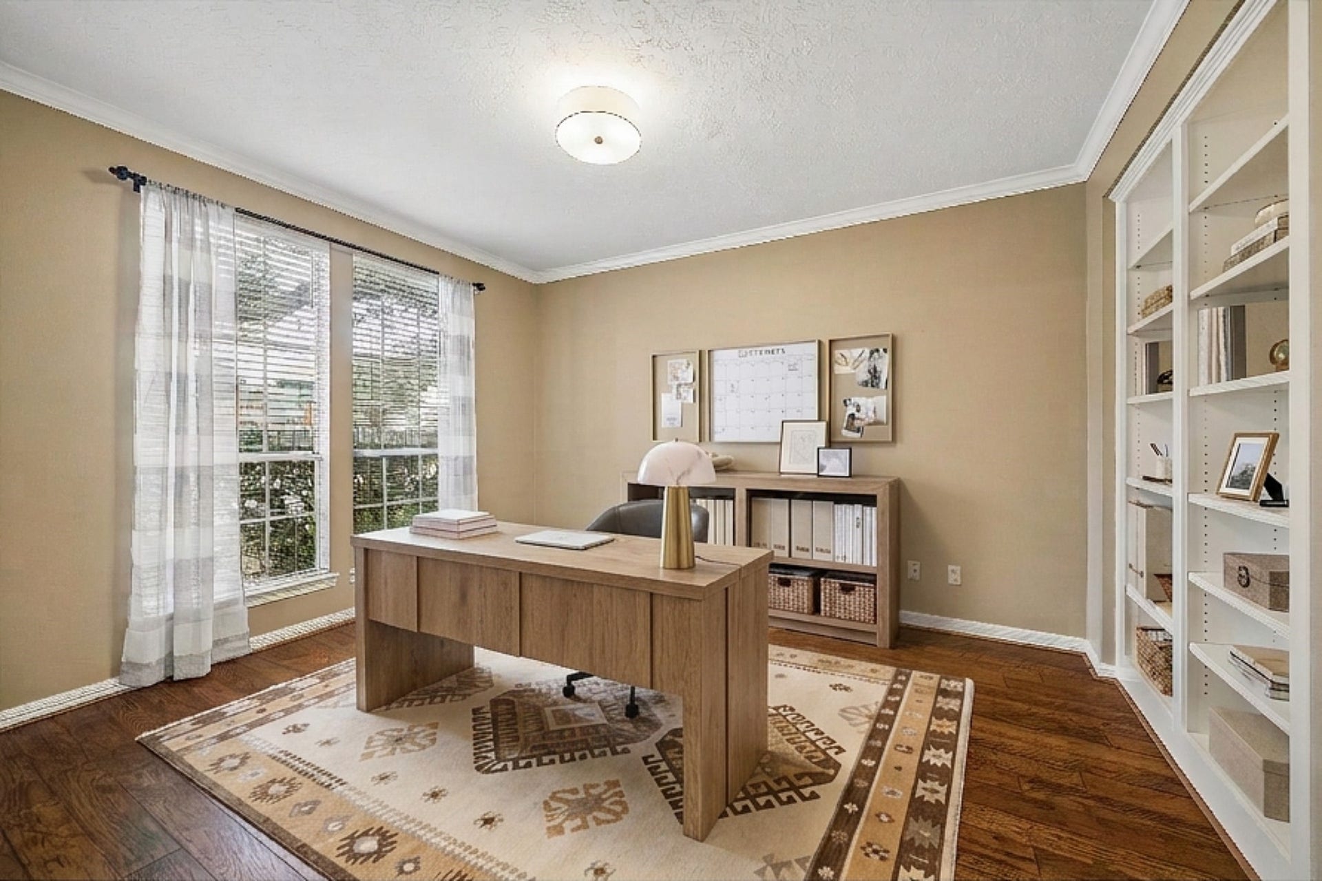 5310 Summerland Ridge Court, Houston, TX 77041 This room serves as an office, library or playroom with hardwood floors, built-in white bookshelves, and double glass French doors. Neutral walls and ceiling light add a cozy feel.
This is a digitally staged image.