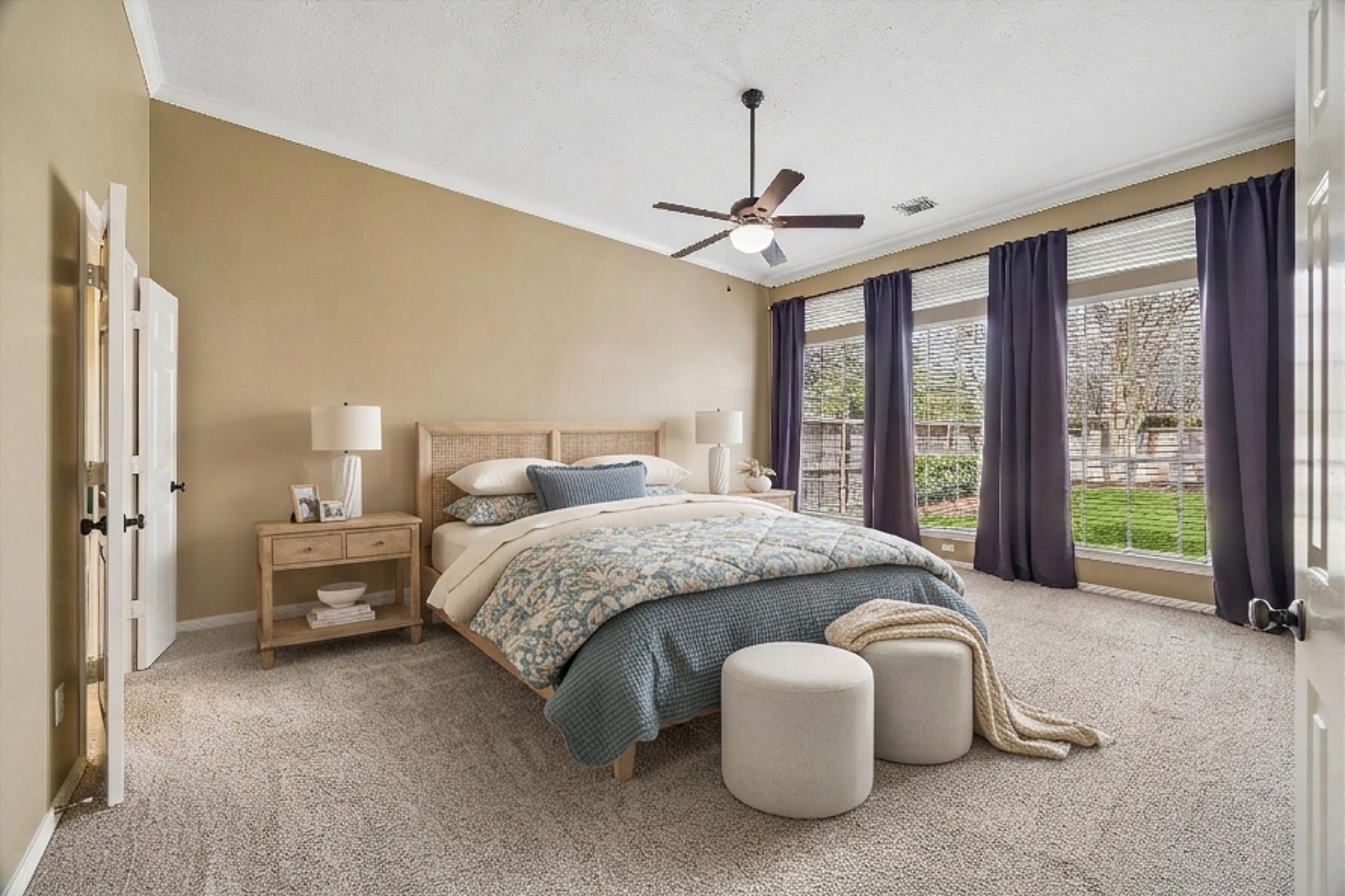 5310 Summerland Ridge Court, Houston, TX 77041 This spacious primary bedroom features neutral walls, plush carpeting, and large windows with curtains, offering ample natural light and a view of the backyard. Primary bedroom and bathrooms are found on the first floor.
This is a digitally staged image.