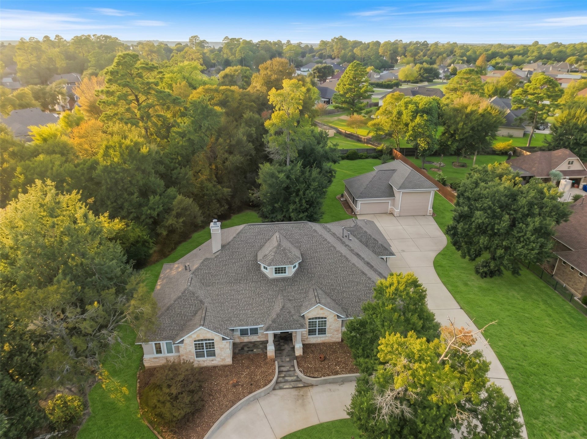 12195 N Lake Vista Drive, Willis, TX 77318 Nestled in a lush, tree-lined neighborhood, this charming home boasts a spacious driveway and a beautifully landscaped front yard, offering privacy and tranquility.