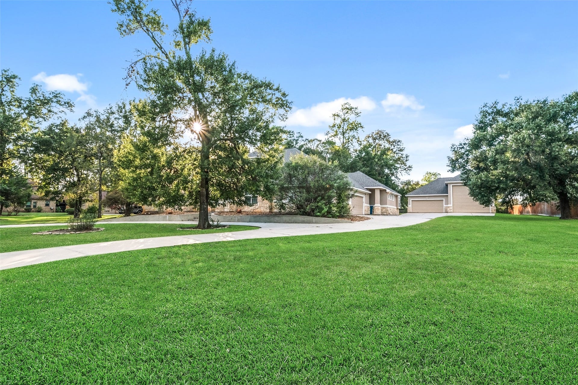 12195 N Lake Vista Drive, Willis, TX 77318 Expansive and inviting, the front yard boasts lush greenery and mature trees, offering a serene welcome home.