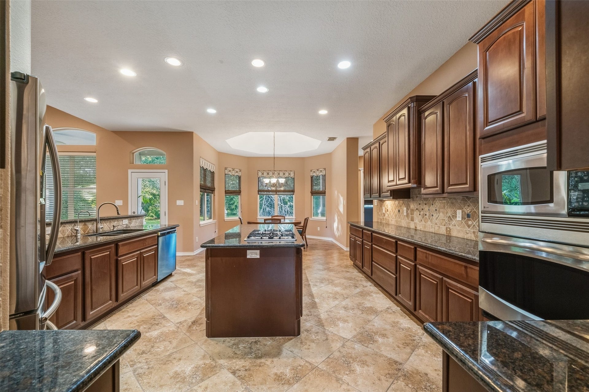 12195 N Lake Vista Drive, Willis, TX 77318 Elegant entryway with arched doorways, featuring beautiful tile flooring that leads into the spacious living areas.