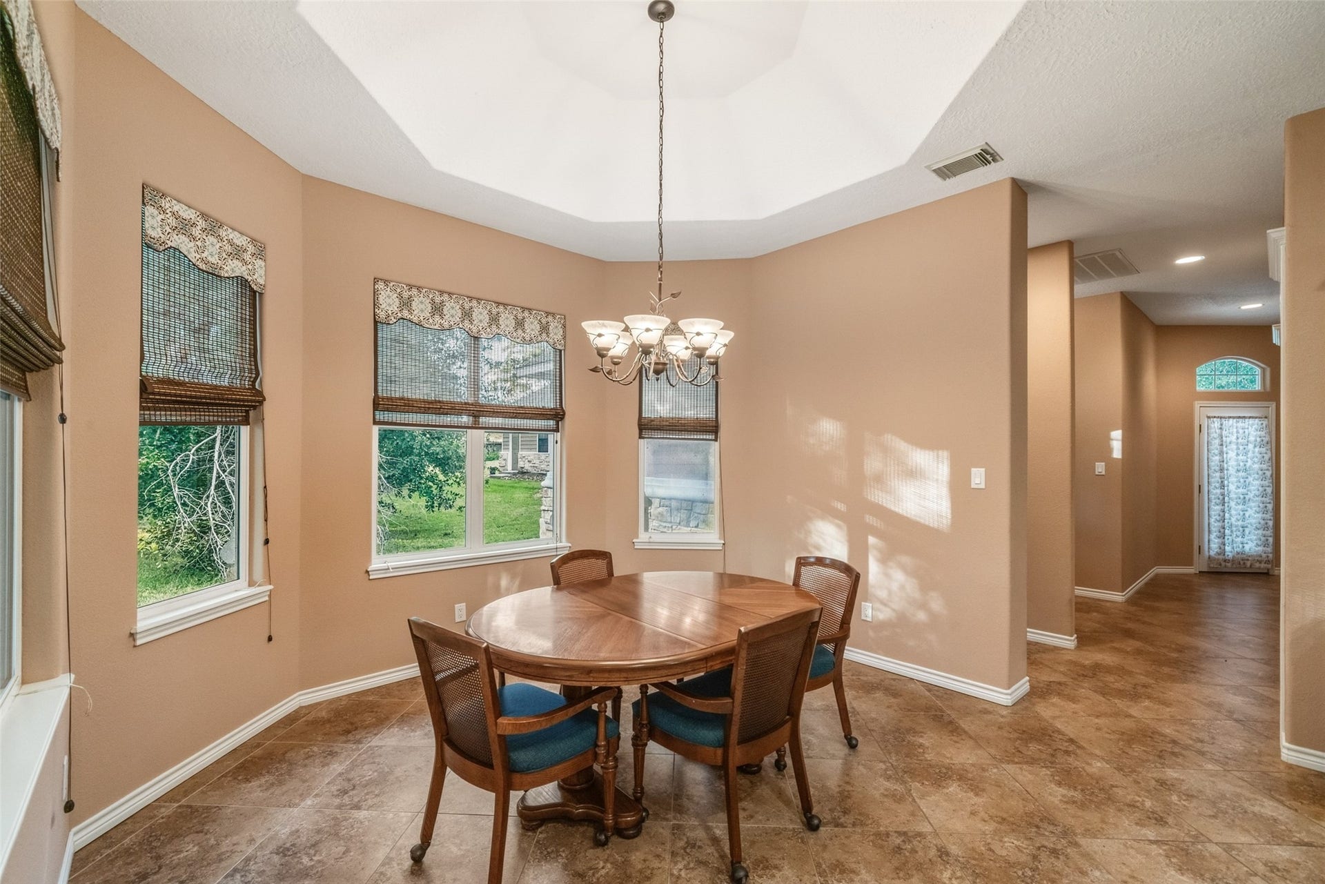 12195 N Lake Vista Drive, Willis, TX 77318 Bright and inviting breakfast room with elegant arched doorways and a large window, perfect for enjoying morning meals bathed in natural light.