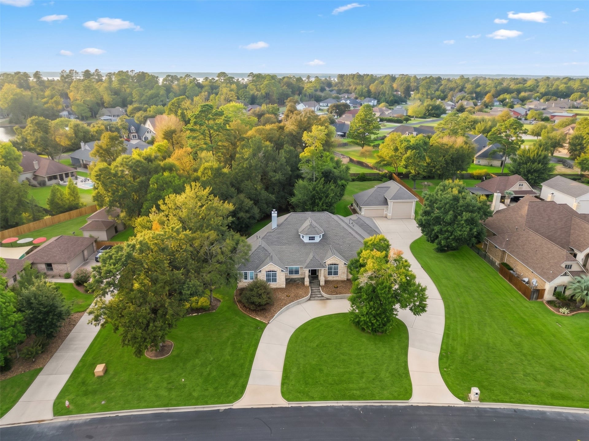 12195 N Lake Vista Drive, Willis, TX 77318 Nestled in a picturesque neighborhood, this stunning home features lush landscaping and a spacious garage perfect for your RV adventures.
