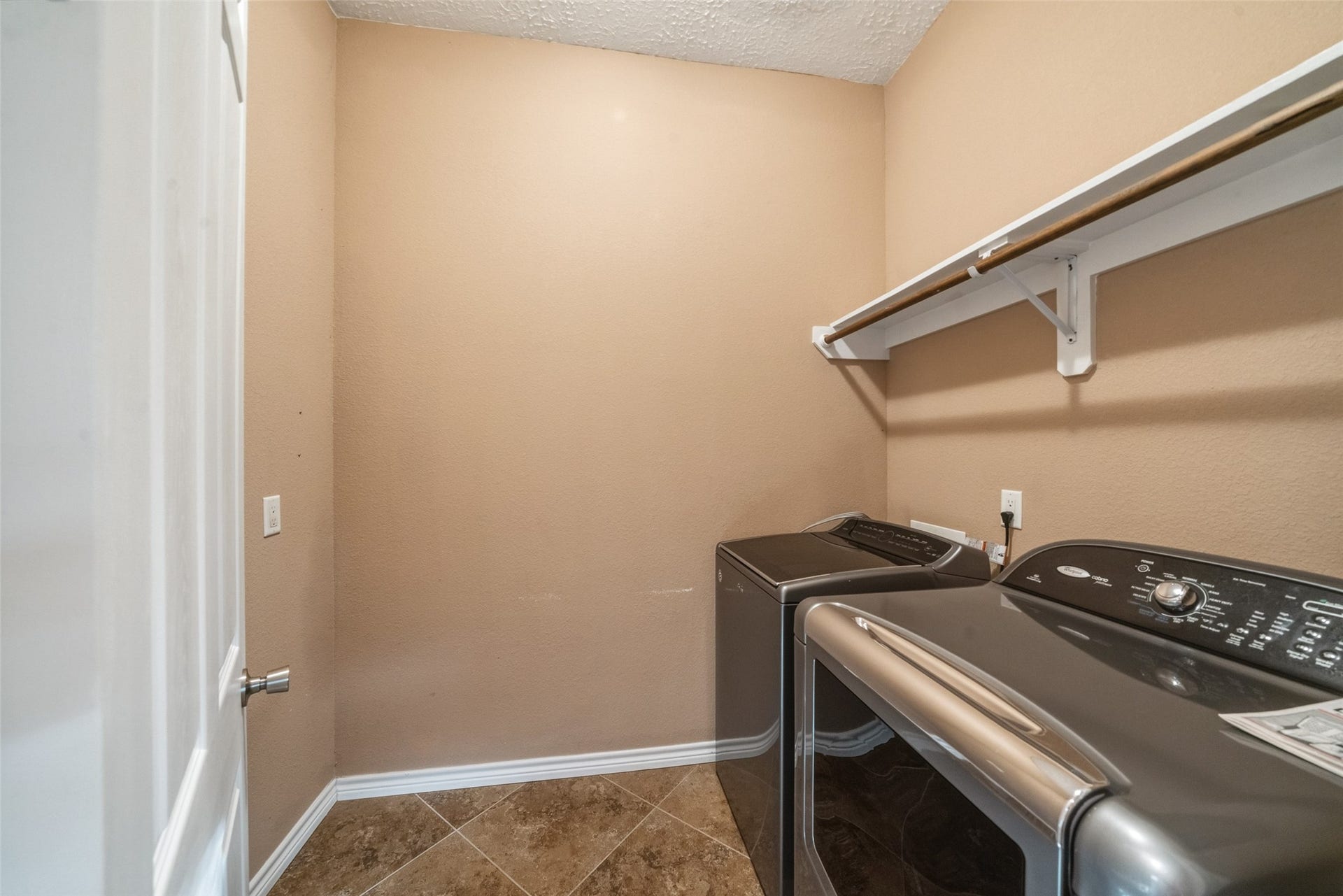 12195 N Lake Vista Drive, Willis, TX 77318 Luxurious slate-tiled shower featuring dual showerheads, a built-in bench, and intricate mosaic accents for a spa-like experience.