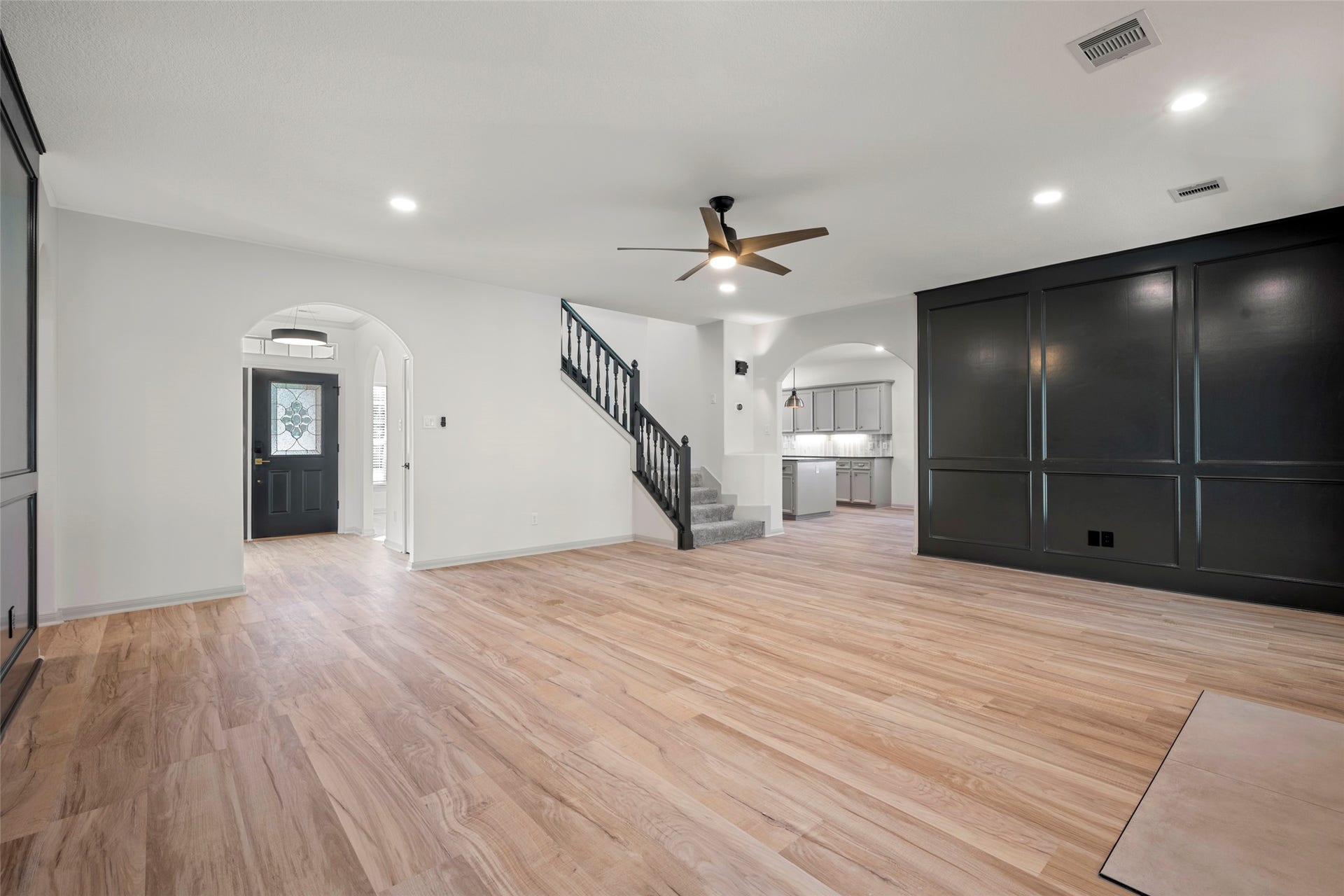 28614 Water Park Way, Spring, TX 77386 Living room features wall paneling, a fireplace and double doors to patio