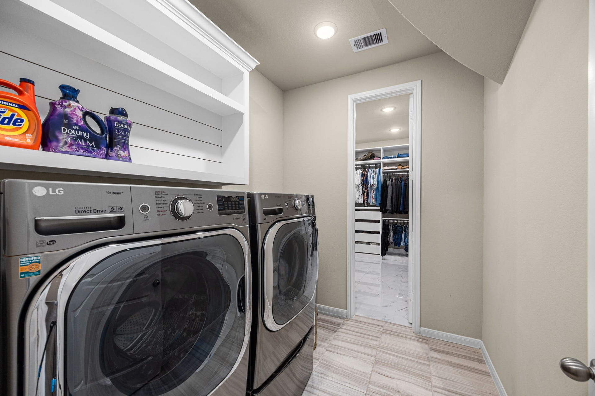 Spacious laundry room can accommodate a full size refrigerator.