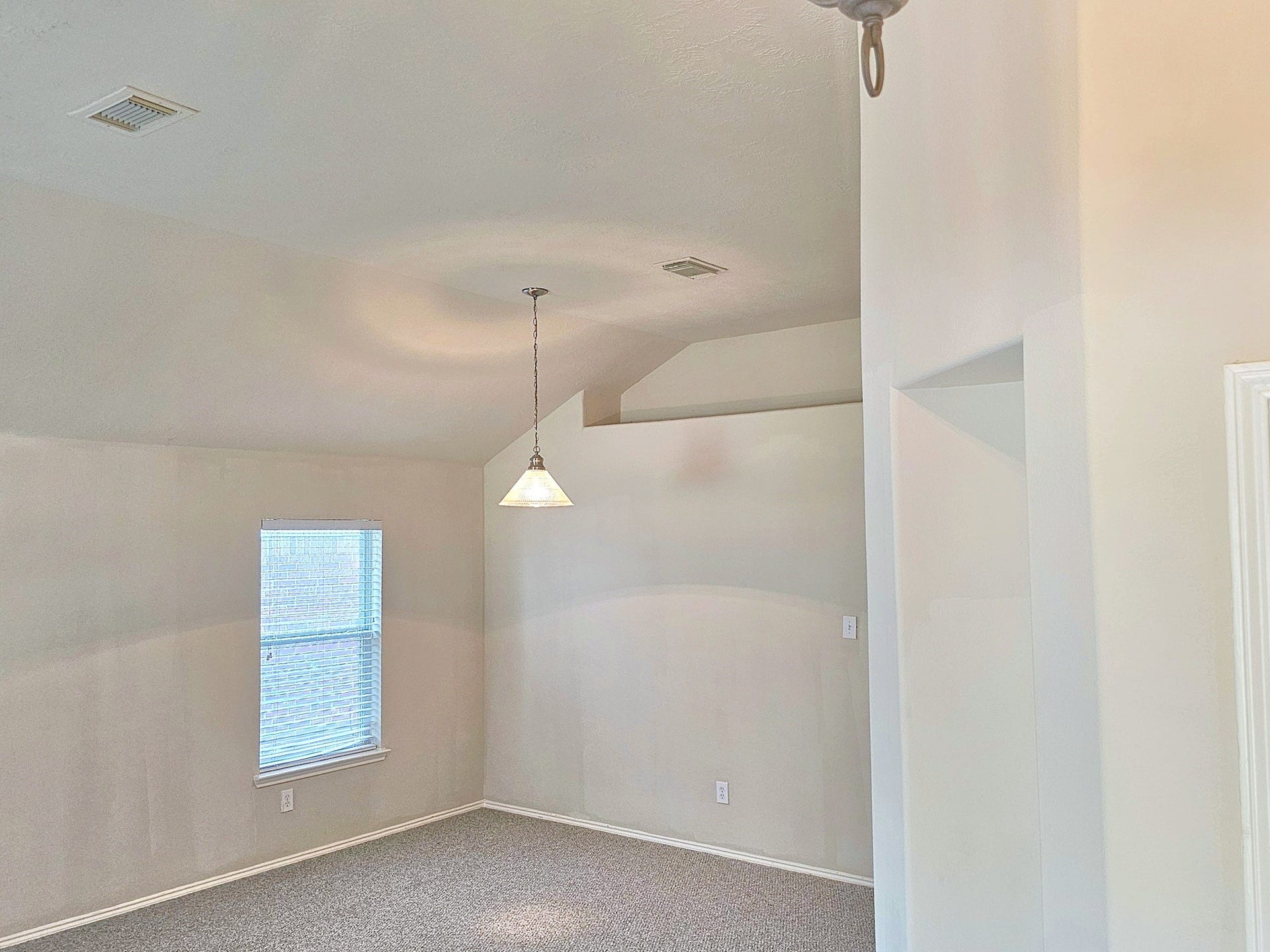 18234 Eton Ridge Court, Richmond, TX 77407 Bright room with vaulted ceilings, soft carpet flooring, and a large window providing ample natural light.