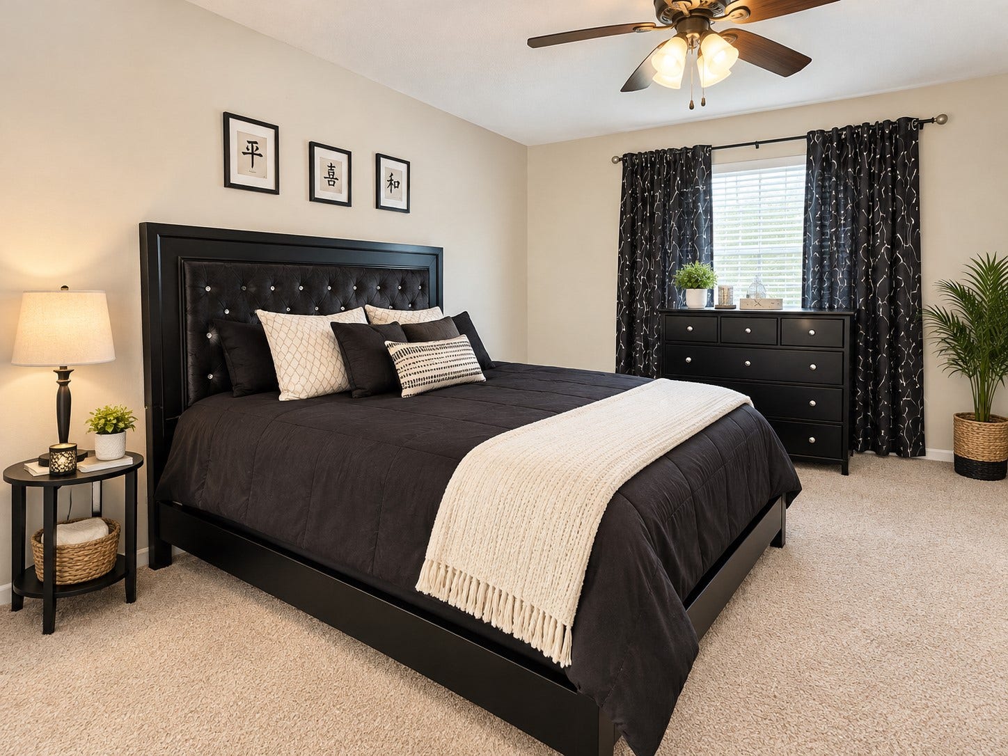 18234 Eton Ridge Court, Richmond, TX 77407 Elegant bedroom featuring a plush black bed with stylish pillows, complemented by a sleek dresser and charming decor.