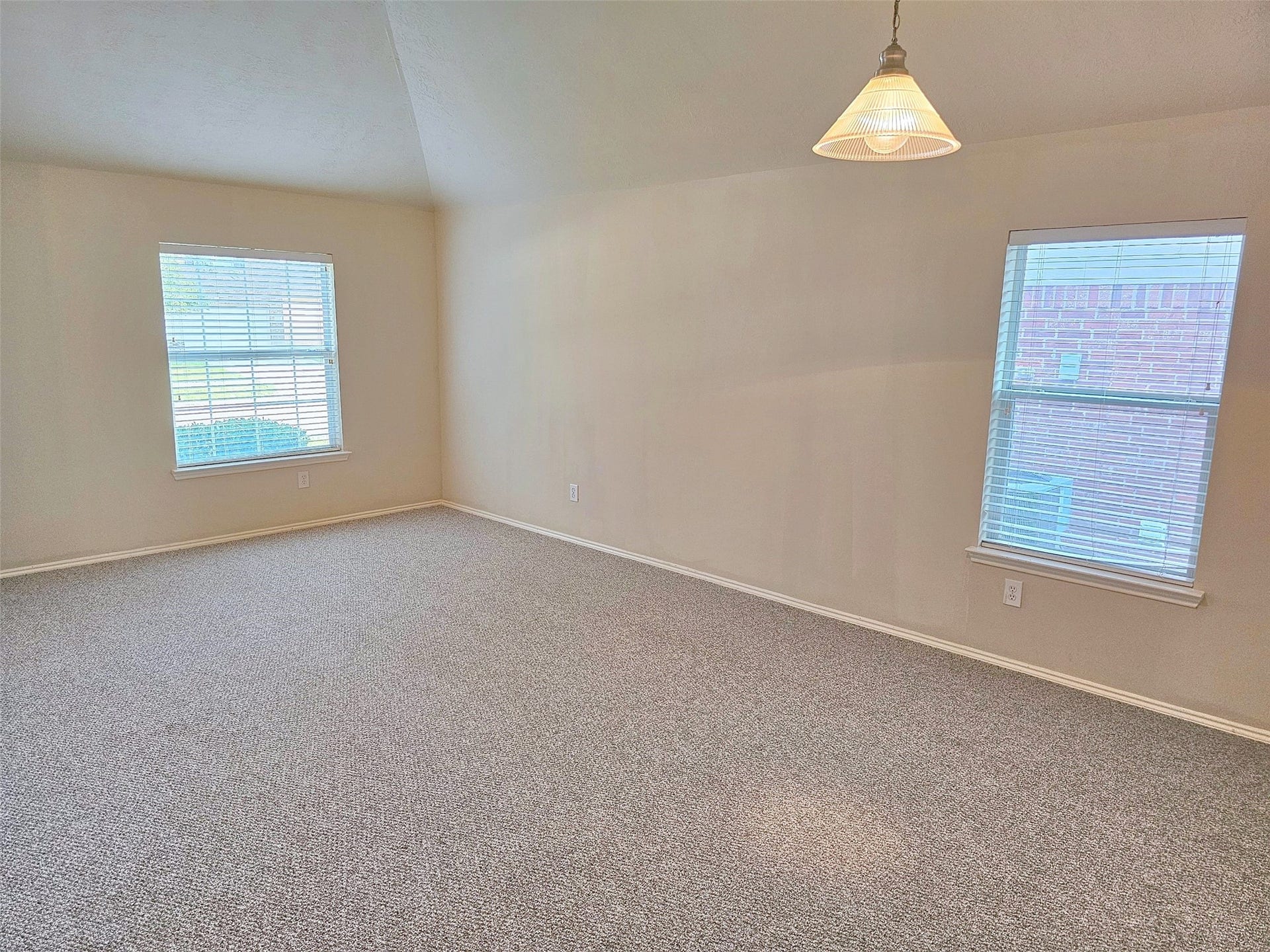 18234 Eton Ridge Court, Richmond, TX 77407 Spacious room with neutral walls, plush carpeting, and abundant natural light from dual windows, perfect for versatile use.