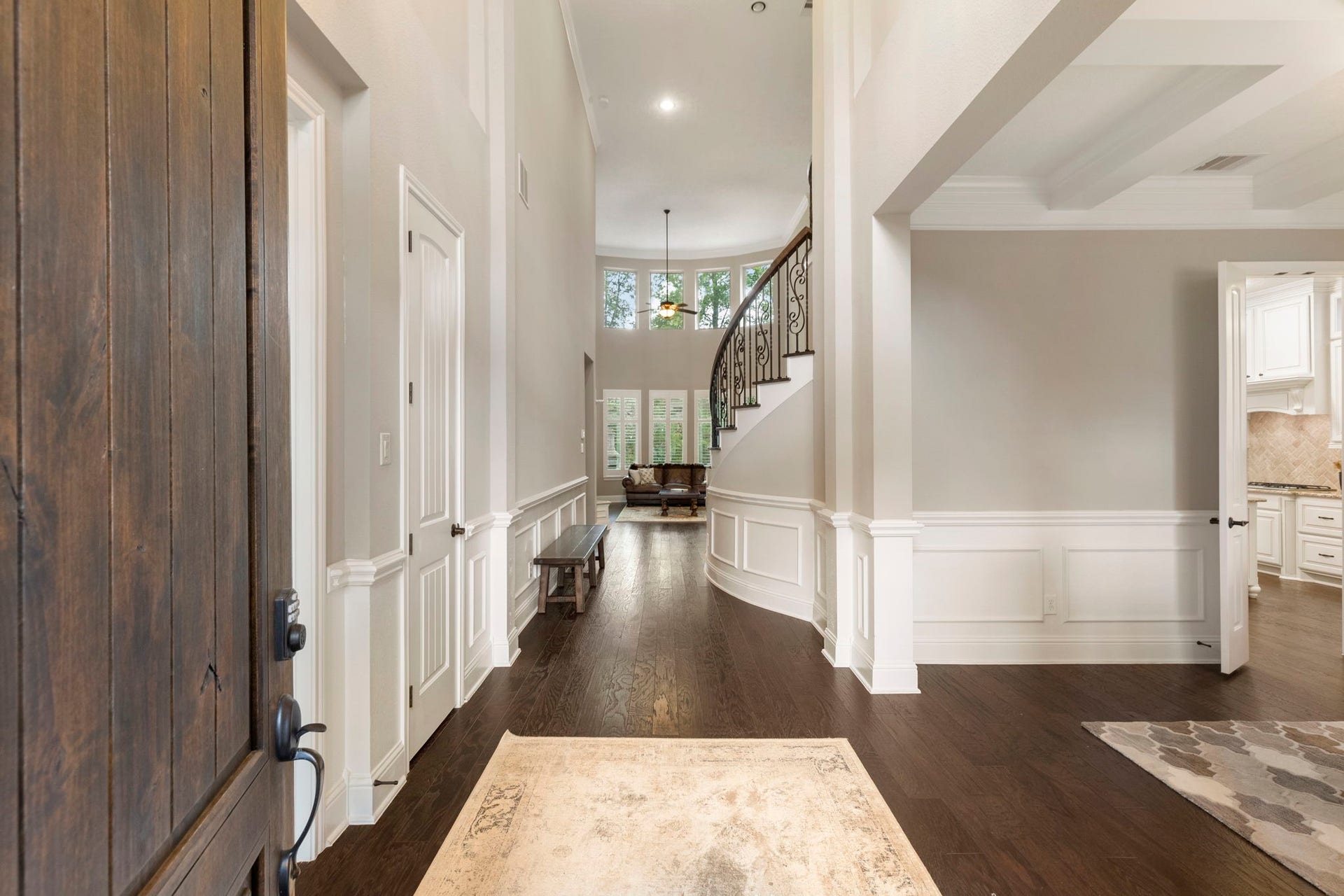 27015 Hidden Grove Landing Drive, Spring, TX 77386 A welcoming first impression with soaring ceilings, decorative lighting, crown molding, and a clear sightline through to the backyard.