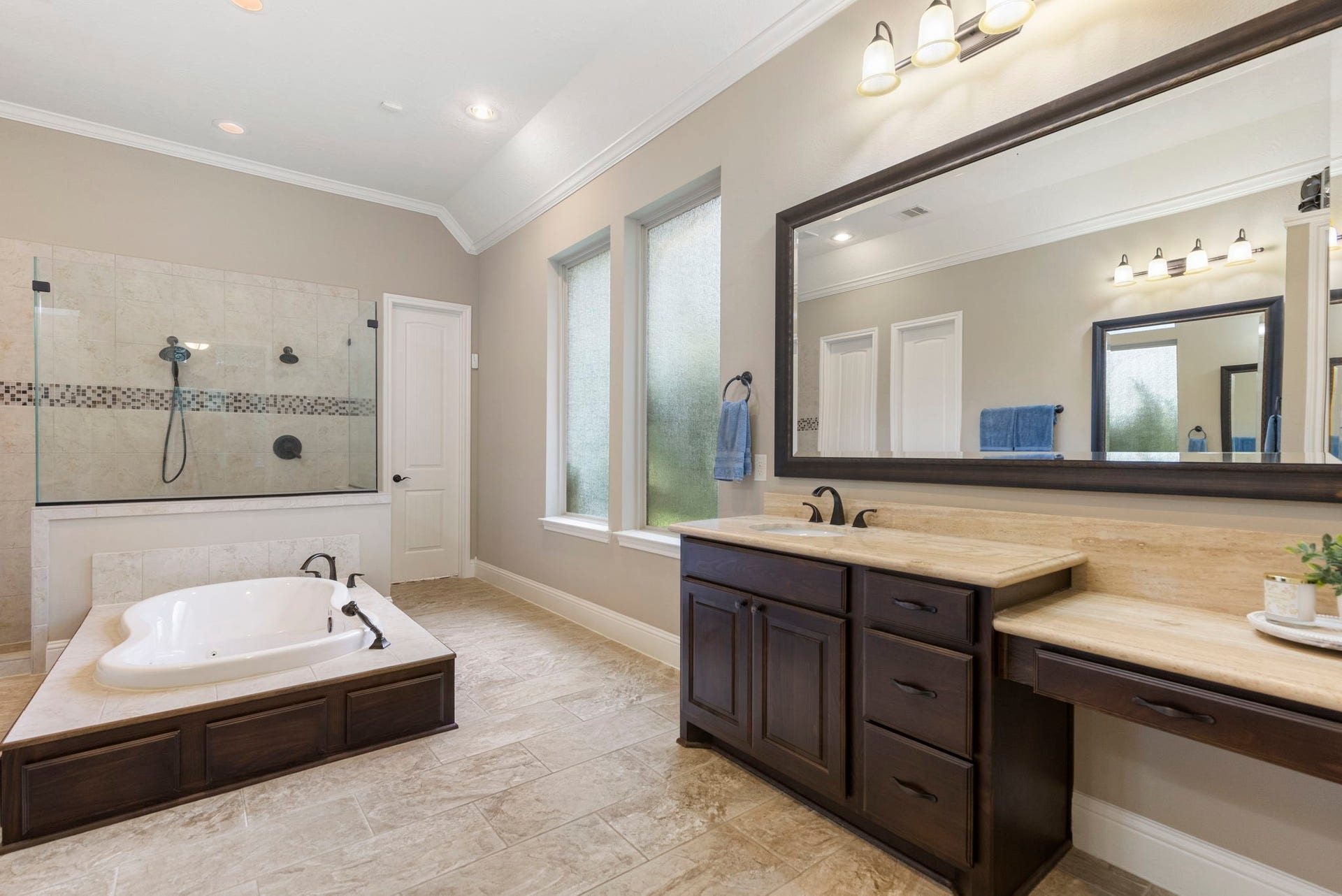 27015 Hidden Grove Landing Drive, Spring, TX 77386 Primary Bath also features two oversized walk-in closets offering custom built-in shelving, drawers, and shoe storage. *Safe stays