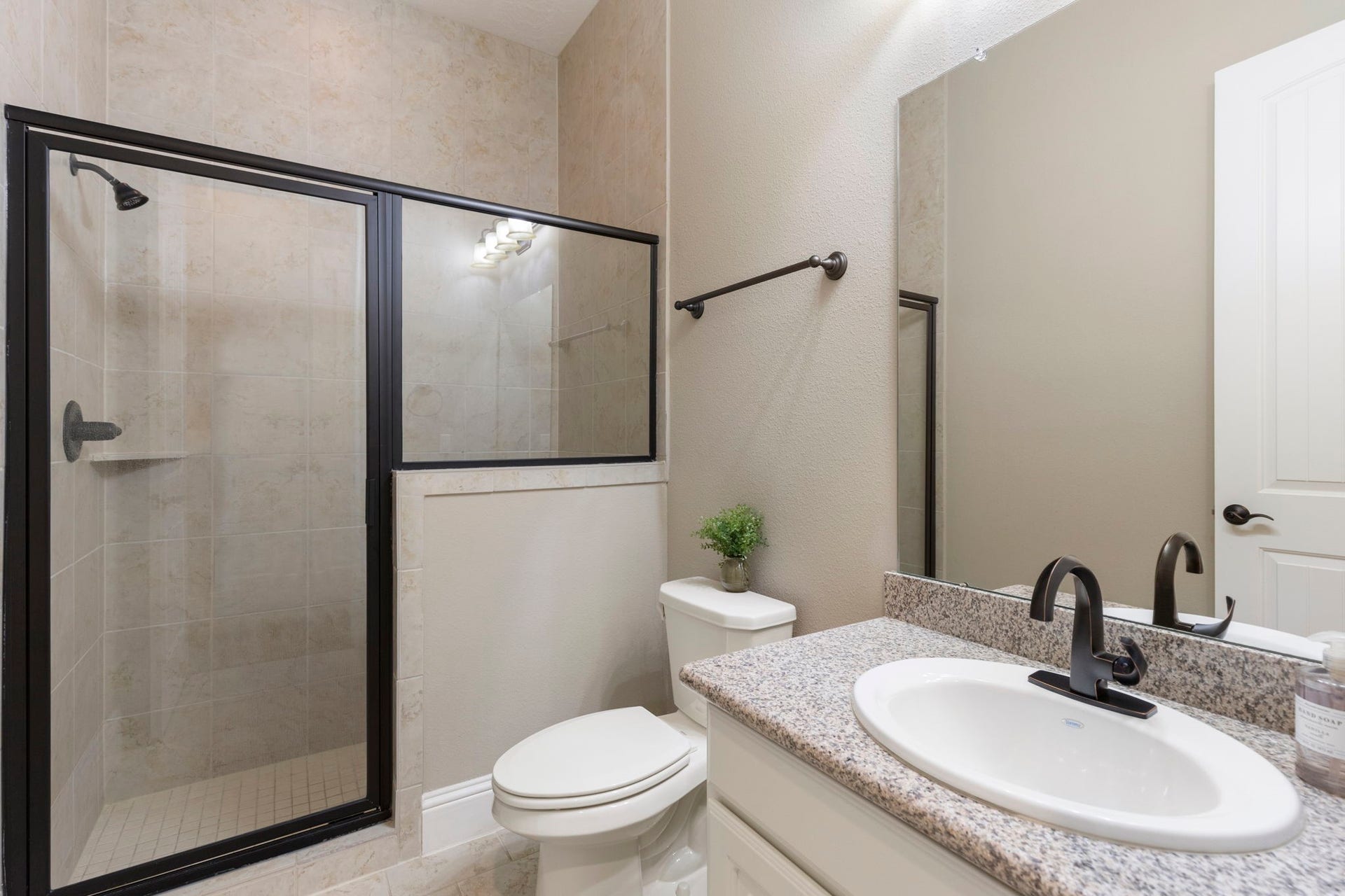 27015 Hidden Grove Landing Drive, Spring, TX 77386 Private guest bath with tile flooring, granite vanity, and walk-in shower with built-in bench seating.