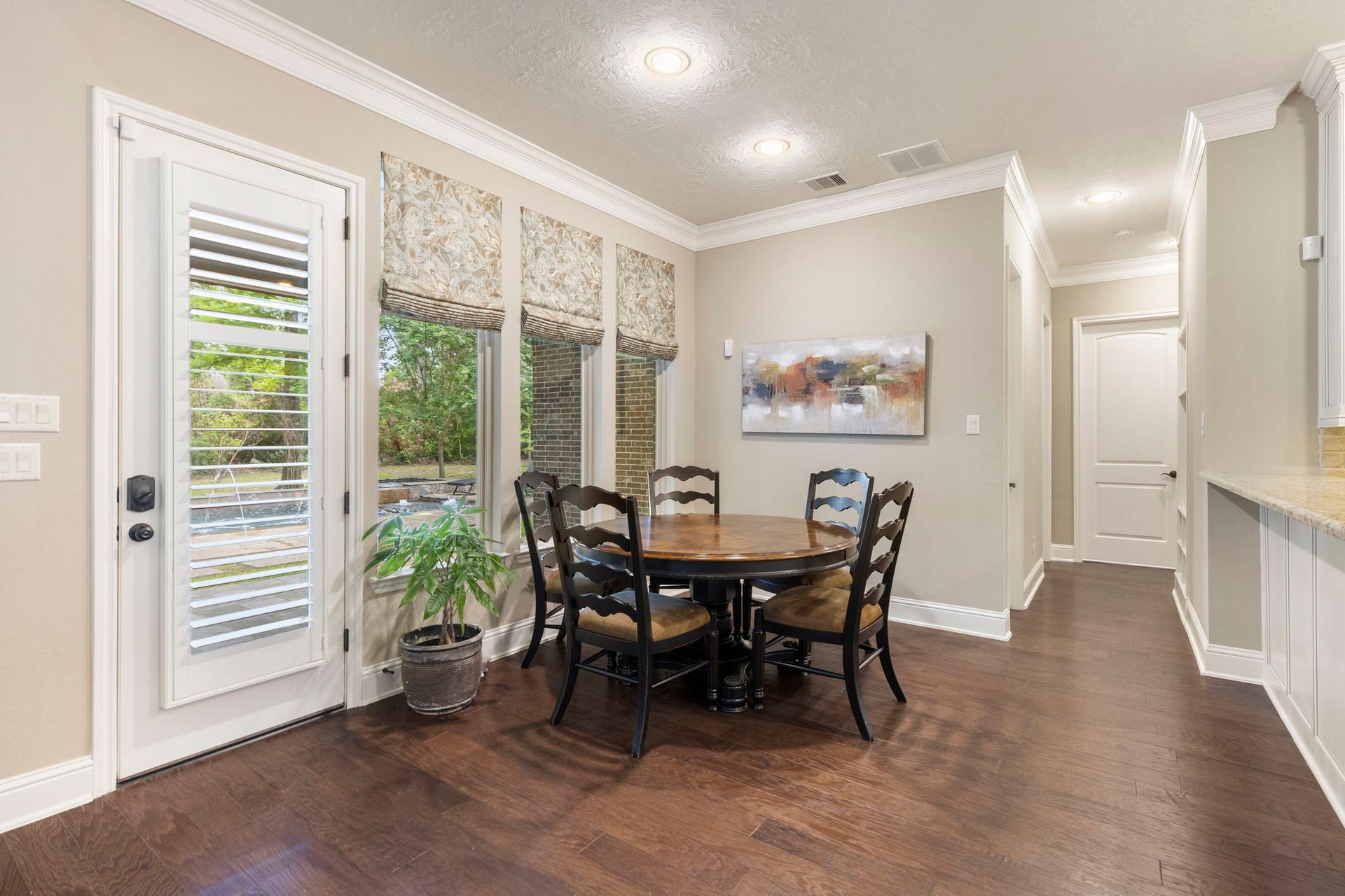 27015 Hidden Grove Landing Drive, Spring, TX 77386 Bright Breakfast Room with pool views, crown molding, wood flooring, and direct access to the covered patio.