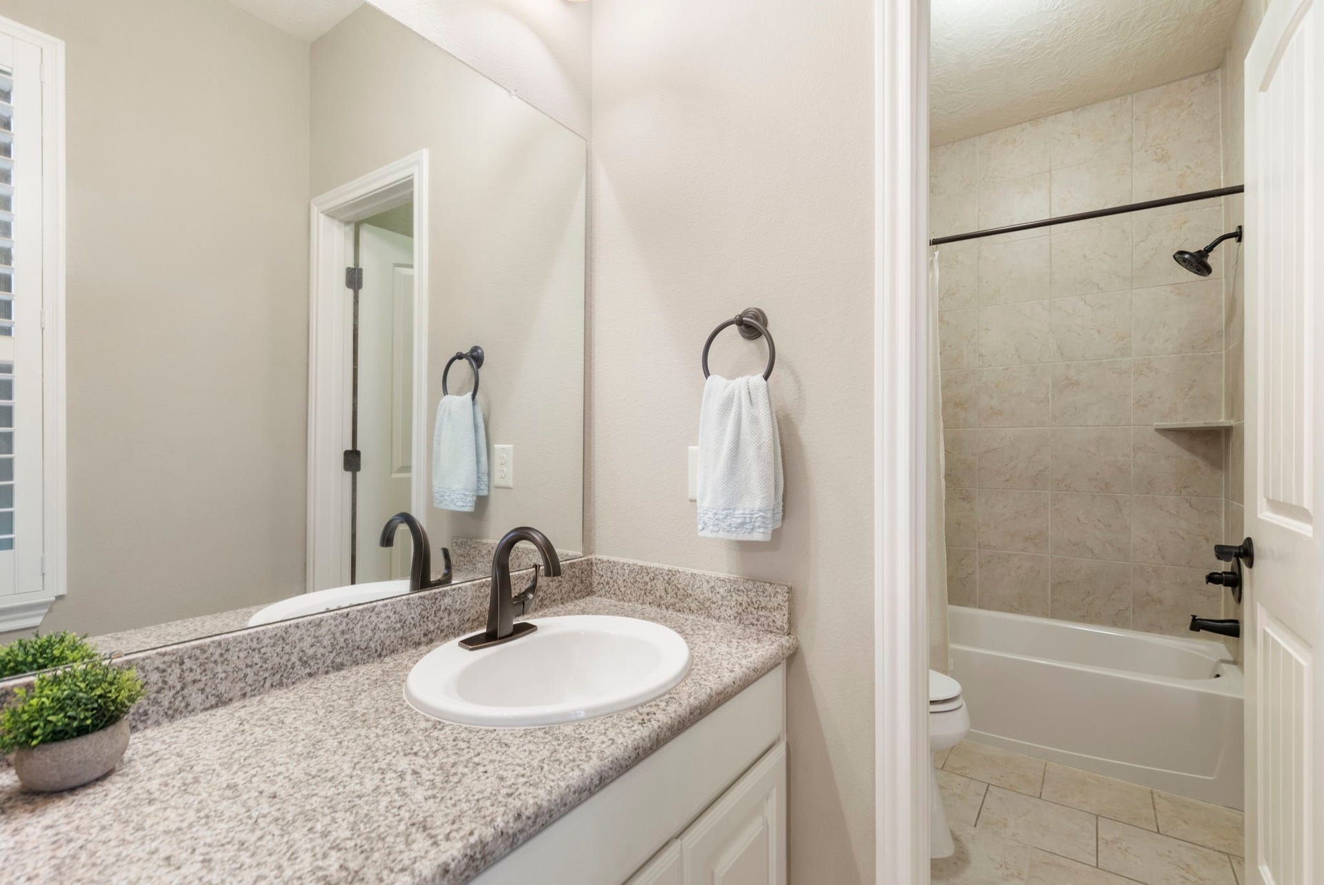 27015 Hidden Grove Landing Drive, Spring, TX 77386 Connecting Bedrooms 4 and 5, this Jack-and-Jill bath offers separate private vanity areas, abundant storage, natural light, and a shared tub/shower space.