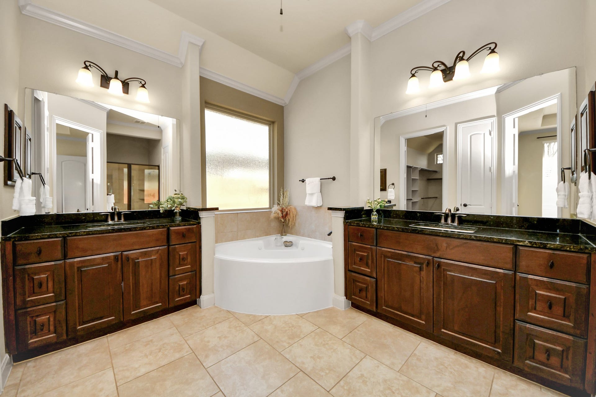 17307 Pentland Court, Richmond, TX 77407 This spa-inspired bath offers a soothing retreat, featuring a soaking tub, dual vanities, and a separate shower designed for comfort and relaxation.