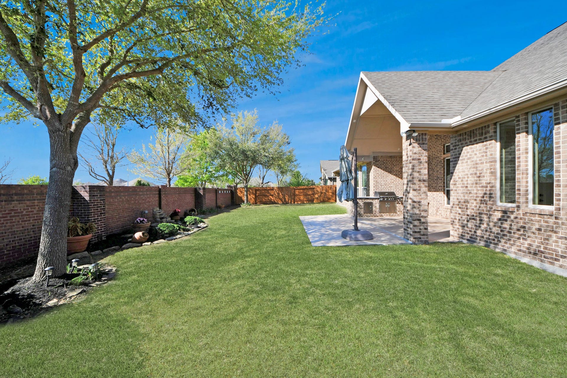 17307 Pentland Court, Richmond, TX 77407 A peaceful backyard view with no rear neighbors, offering a sense of openness, while nearby walking trails and a lake with a fountain invite you to enjoy the outdoors just moments from home.