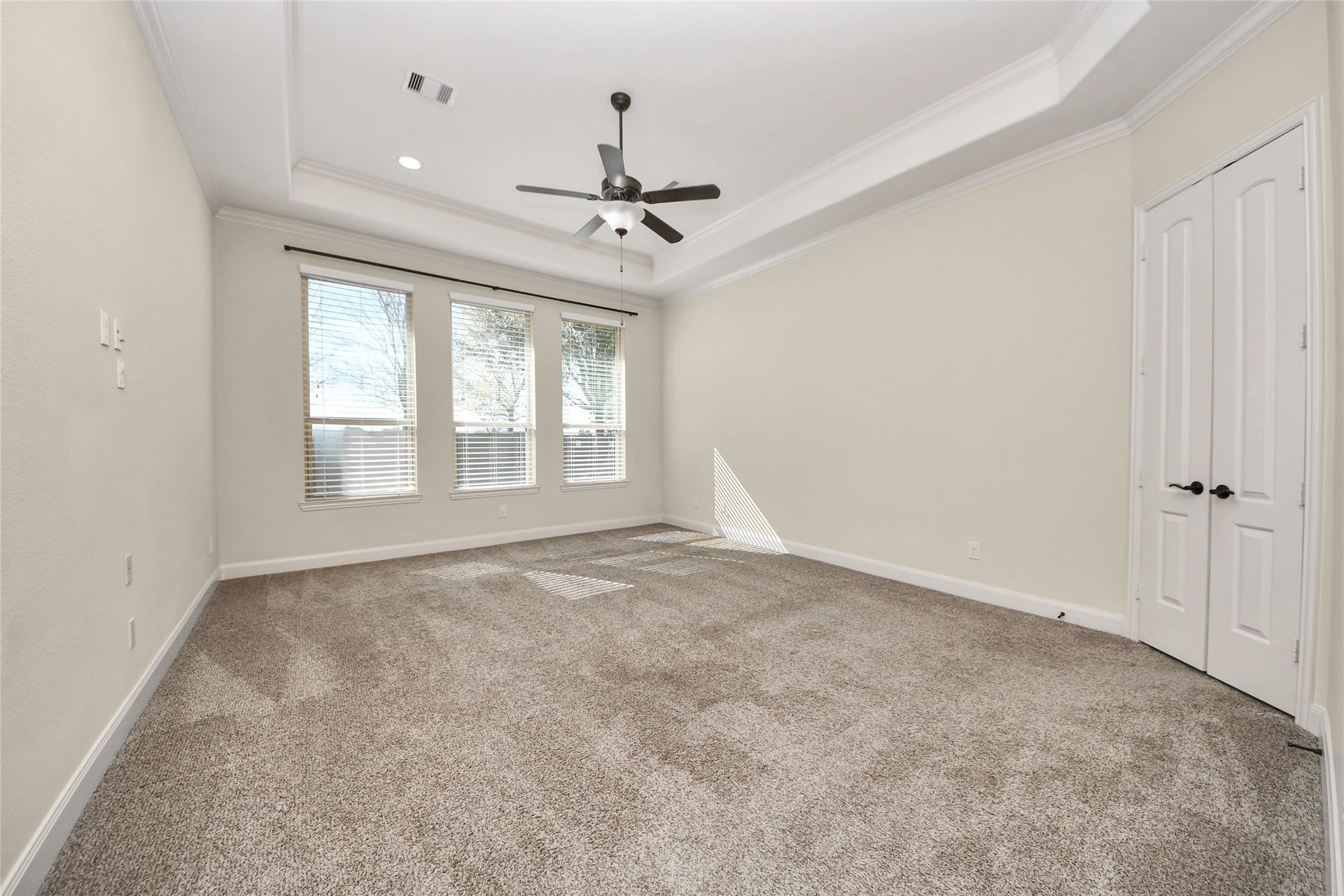 17307 Pentland Court, Richmond, TX 77407 Tucked away for privacy, the generously sized primary bedroom offers a peaceful retreat, featuring expansive windows, refined ceiling details, and elegant French doors that open to the ensuite bath.