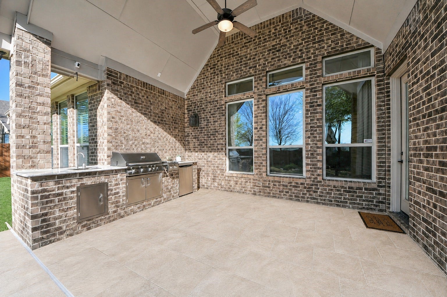 17307 Pentland Court, Richmond, TX 77407 The back patio is made for easy entertaining with a built-in outdoor kitchen, while no rear neighbors offer added privacy. A garden and tranquil water feature along the brick wall create a serene backdrop.