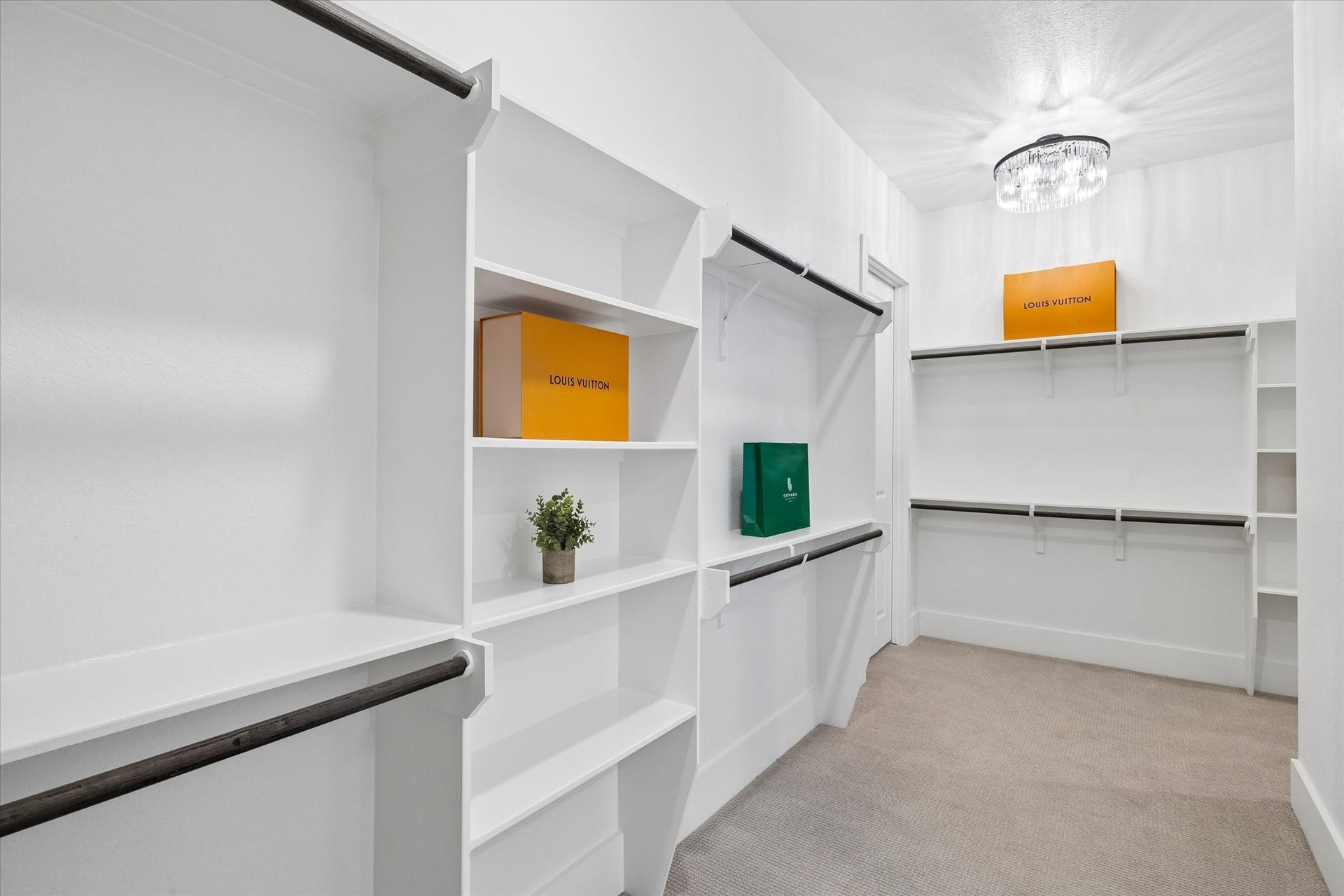 27720 Hazelbrook Lane, Spring, TX 77386 Your MASSIVE Primary Bedroom Closet conveniently has a door connecting to your Laundry Room. As you turn the corner to the right, there is an additional hallway of closet space with custom built-ins.