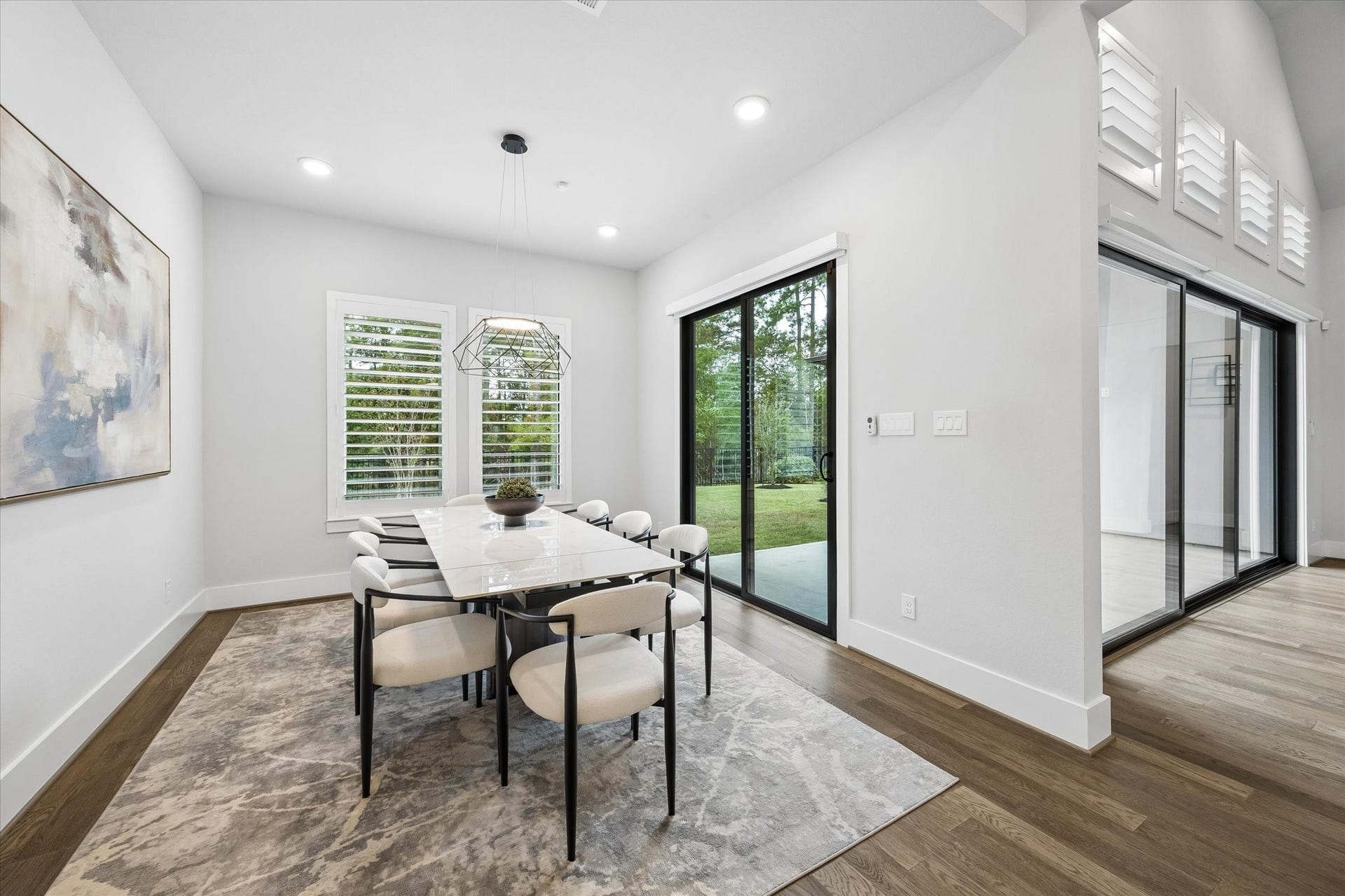 27720 Hazelbrook Lane, Spring, TX 77386 Your LARGE Kitchen Nook is approx 16'x12' and features an additional set of Modern Sliding Glass Doors. Upgraded Modern Chandelier, Recessed Lighting and continued plantation shutters. Notice the stunning Wooded views from this room looking out from your Kitchen.