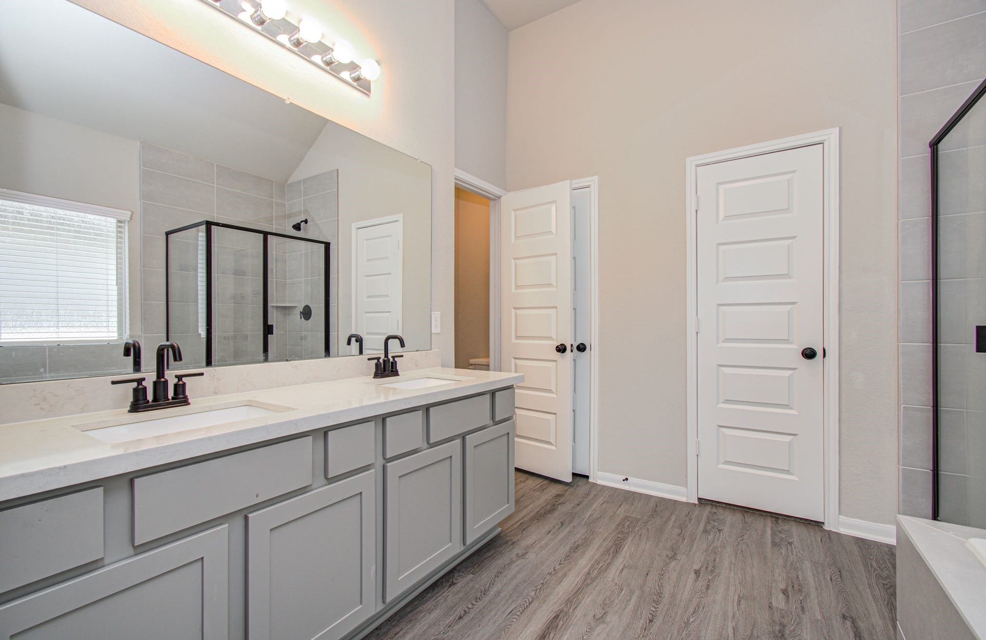 Wonderful primary bath with dual quartz vanities and extended mirrior