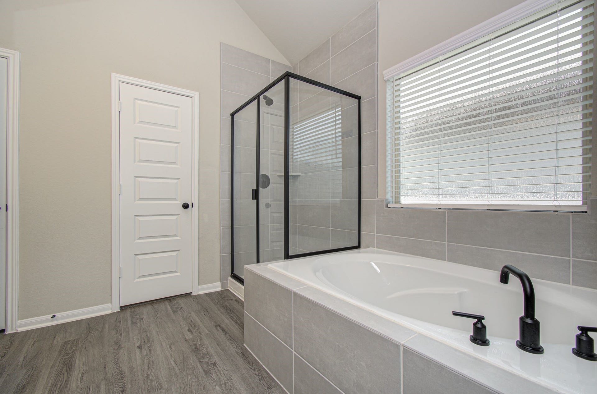 Upgraded primary bath includes separate garden soaking tub and separate shower