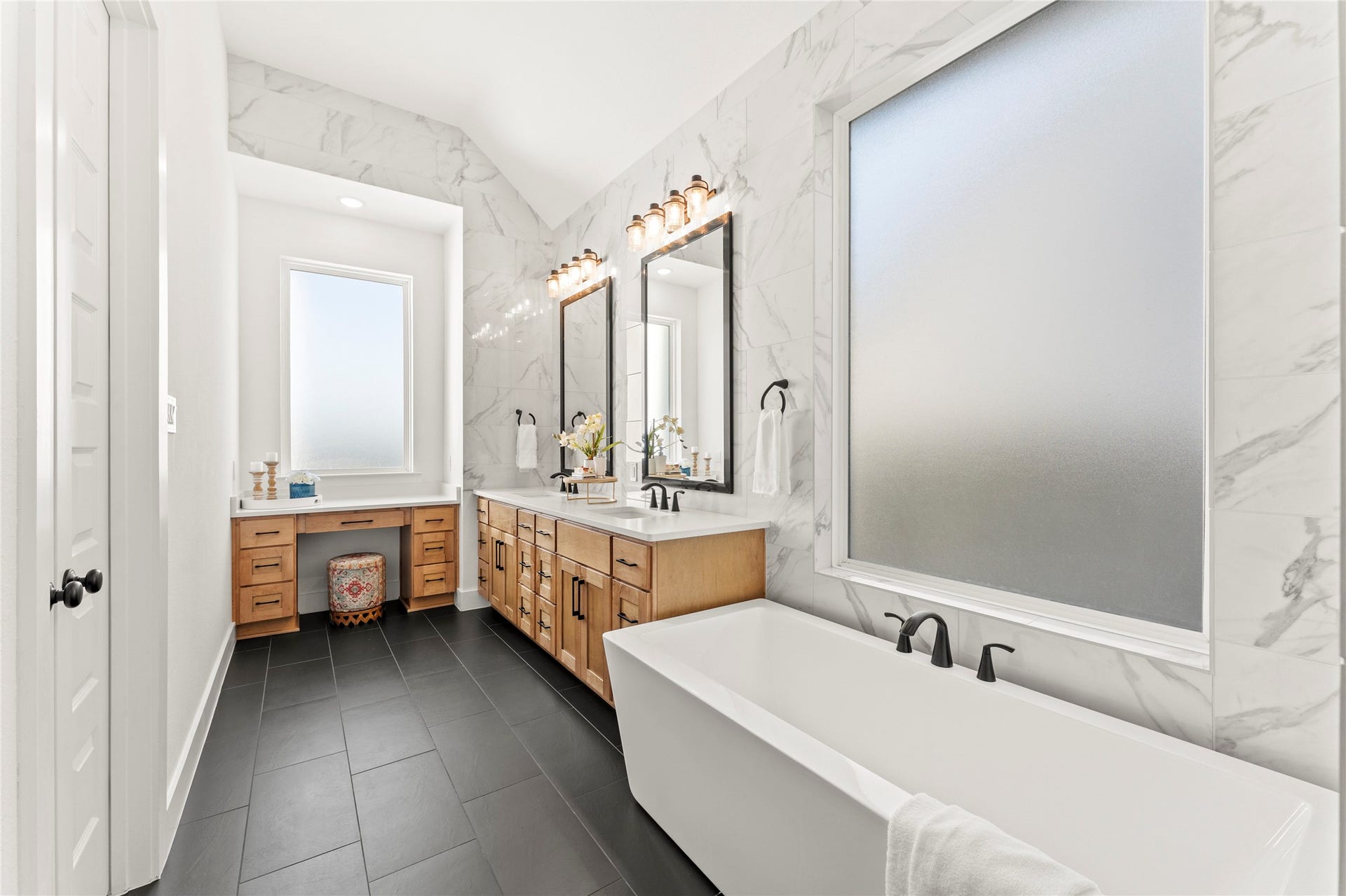 1934 Pleasant Grove Drive, Missouri City, TX 77459 Sleek black hardware and chic light fixtures beautifully contrast the crisp white finishes and dark tiled flooring for a truly high-end, sophisticated feel.