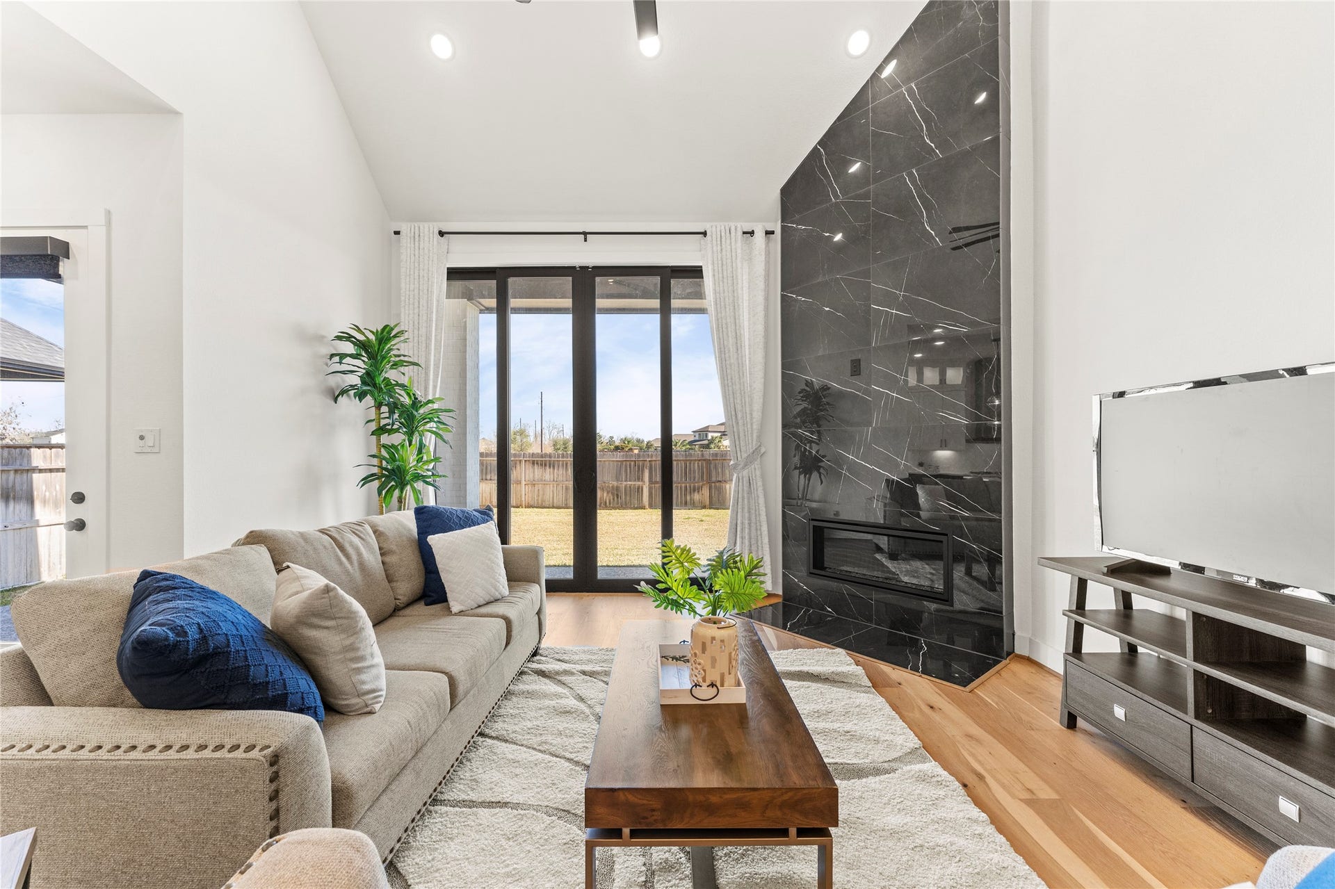 1934 Pleasant Grove Drive, Missouri City, TX 77459 This breathtaking living room is the heart of the home, featuring soaring high ceilings and a magnificent floor-to-ceiling tiled fireplace!