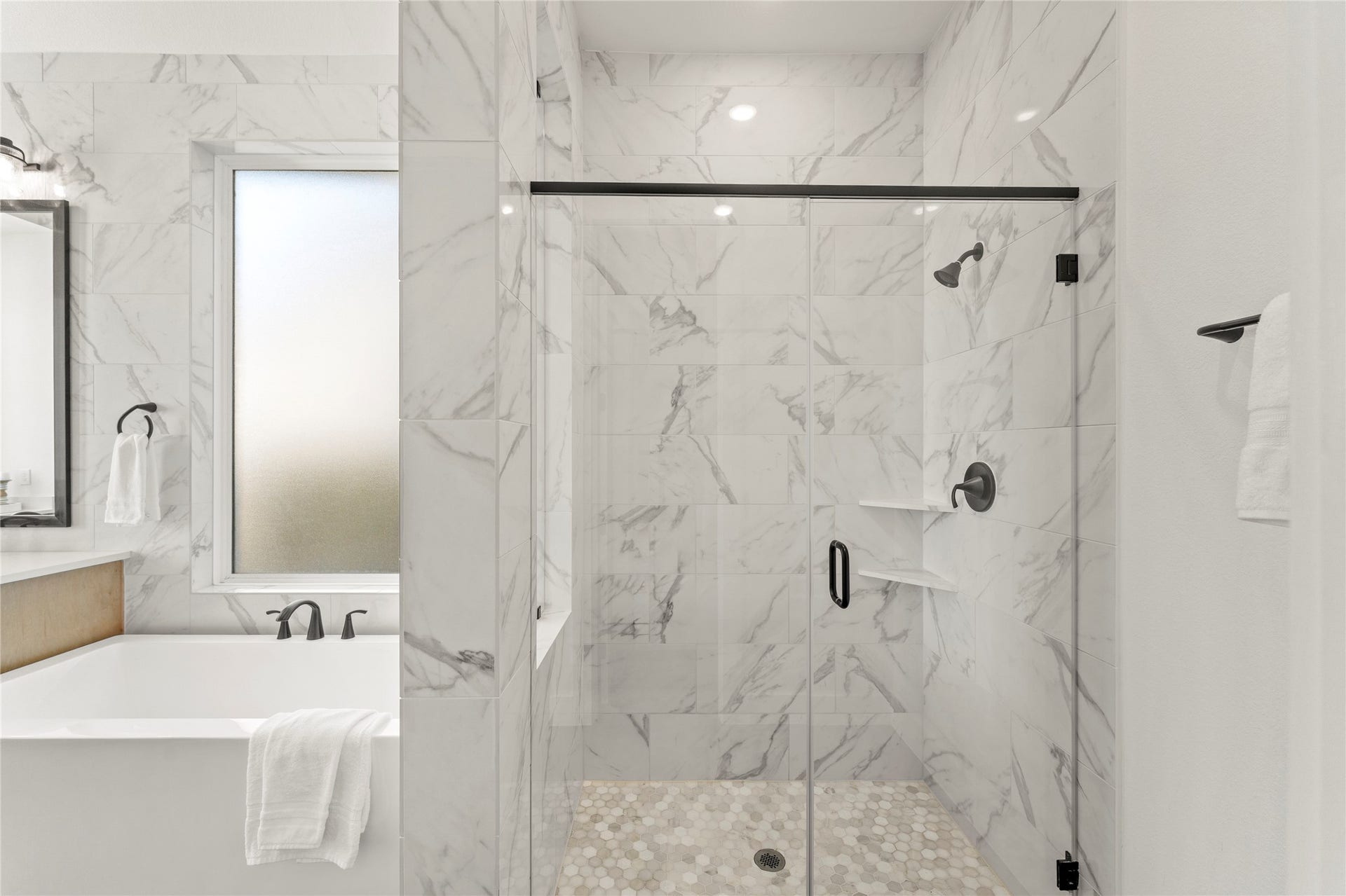 1934 Pleasant Grove Drive, Missouri City, TX 77459 You will love the modern freestanding soaking tub and the massive walk-in shower, both wrapped in elegant floor-to-ceiling marble-patterned tile.