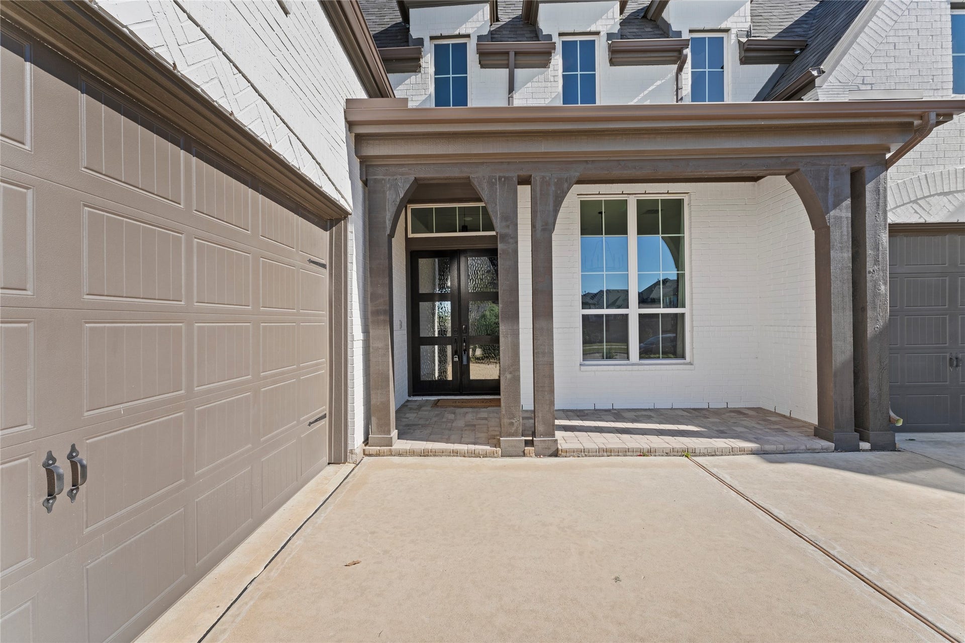1934 Pleasant Grove Drive, Missouri City, TX 77459 a striking double glass door entrance! The charming front porch invites you into a space where modern elegance meets warm, neighborhood charm.