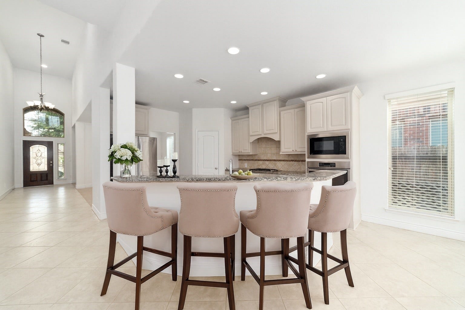 Virtually Staged - Elegance and functionality as you gaze from the family room into the modern kitchen.