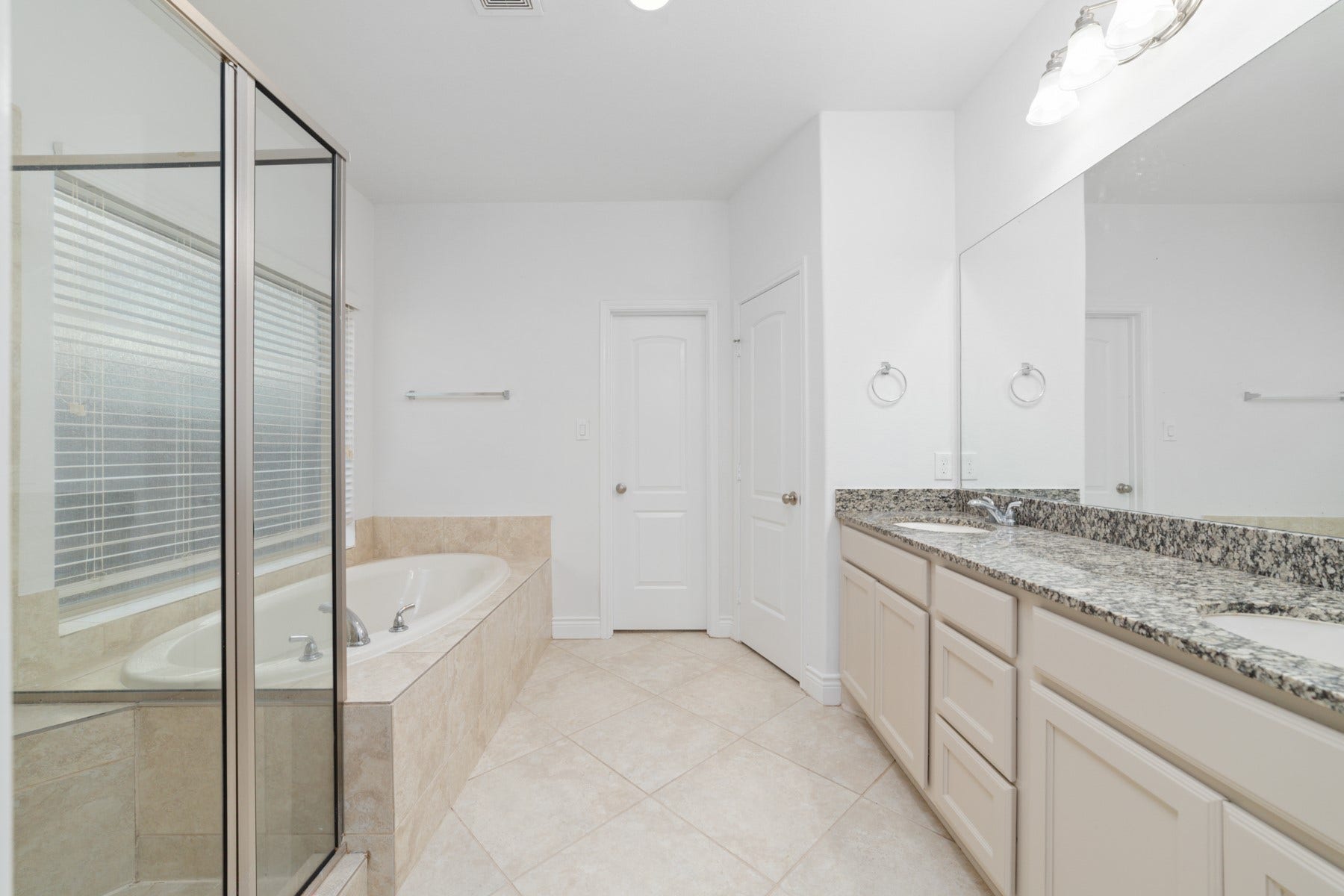 Dual sinks and upgraded granite counters in the master bathroom.