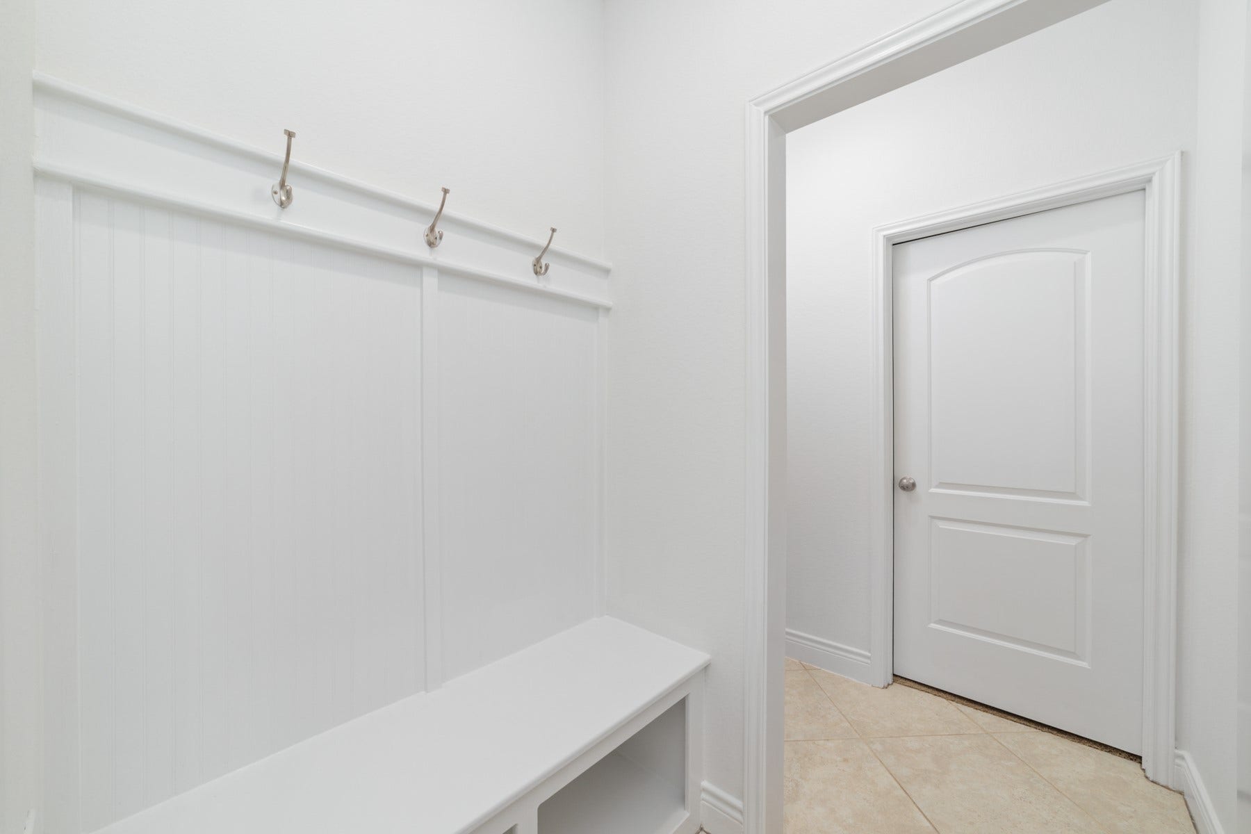 Mud Room - Elegant custom beadboard paneling, creating a charming and functional entryway.