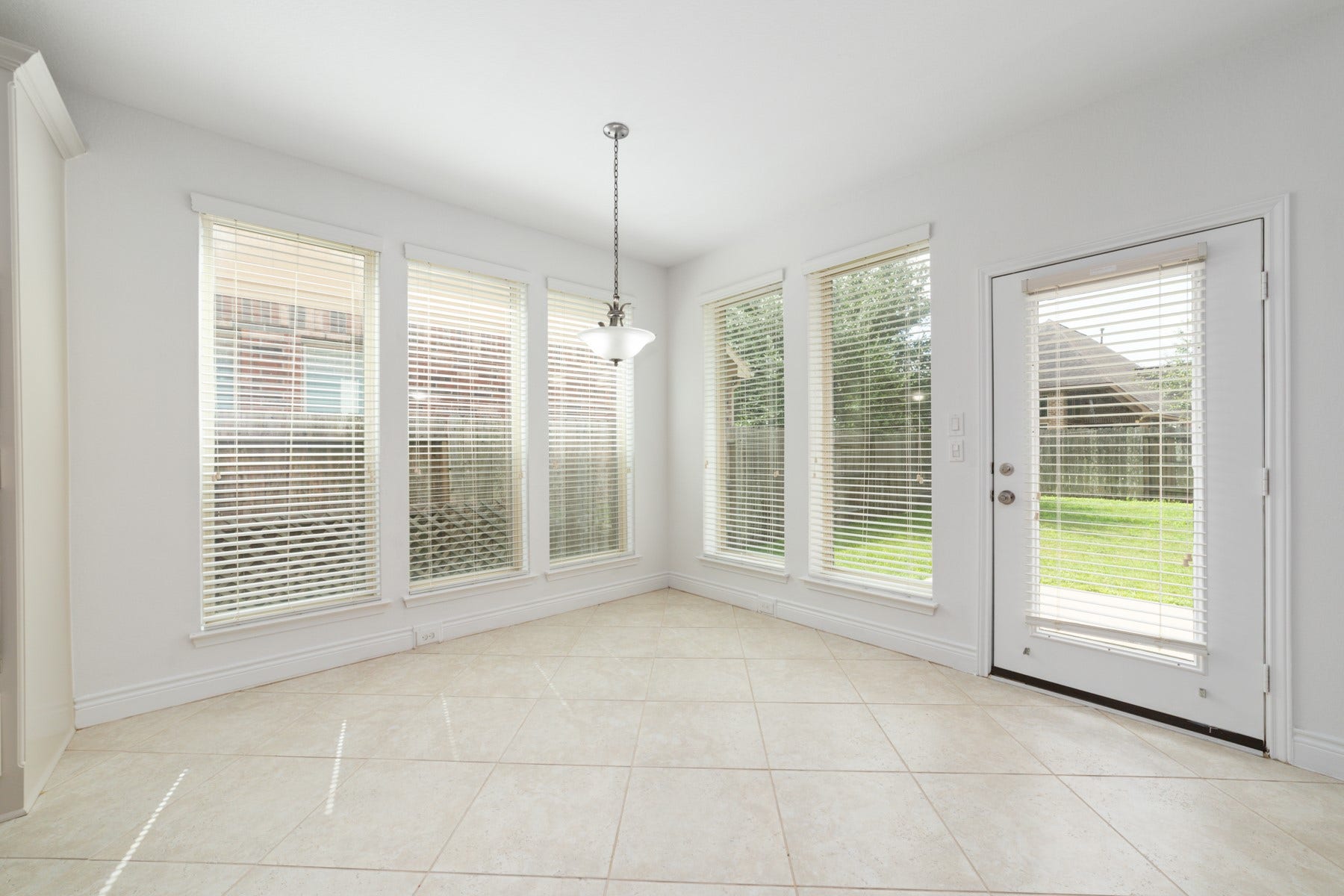 Bright and inviting, this breakfast nook features a door leading to the back patio.