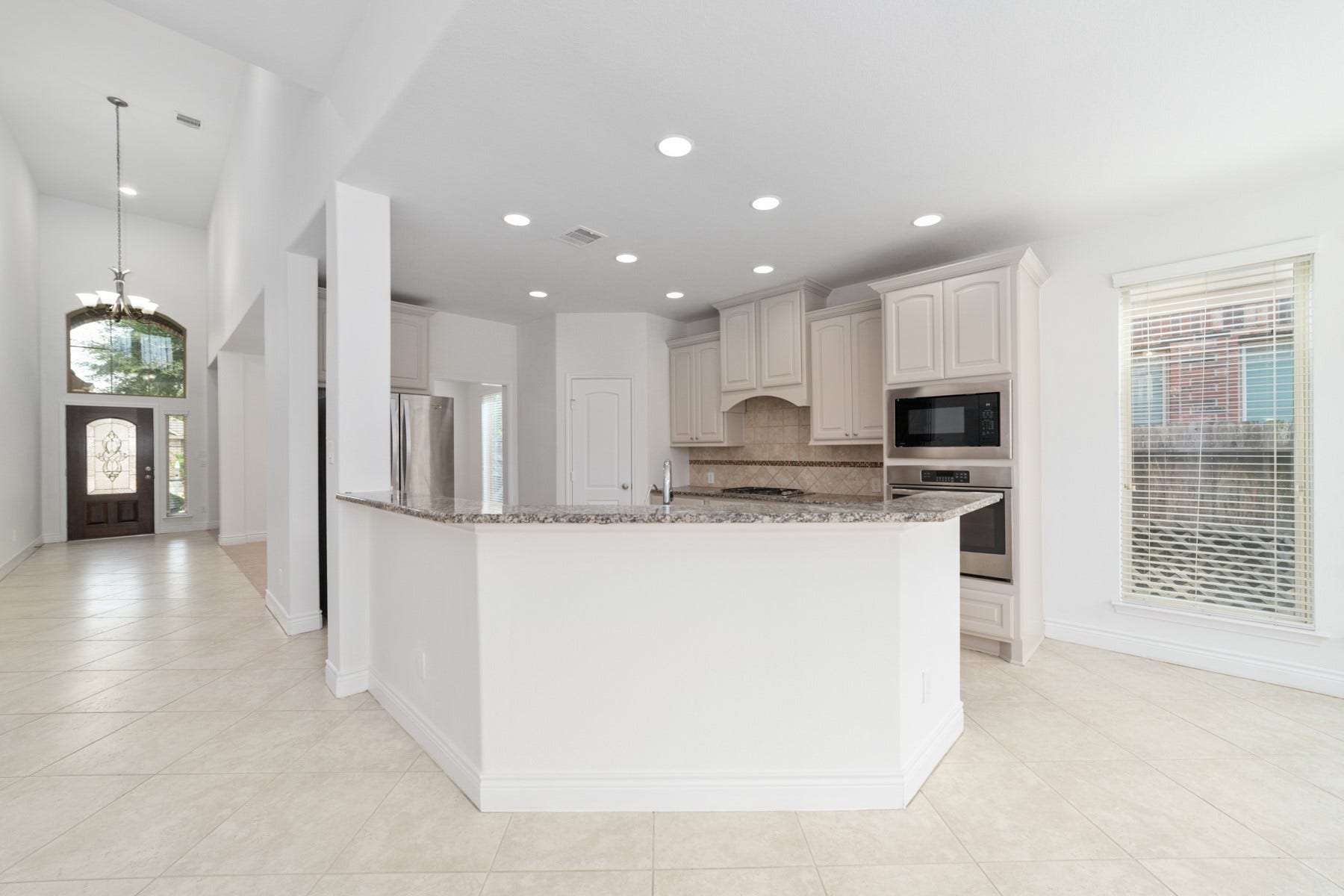 Elegance and functionality as you gaze from the family room into the modern kitchen.