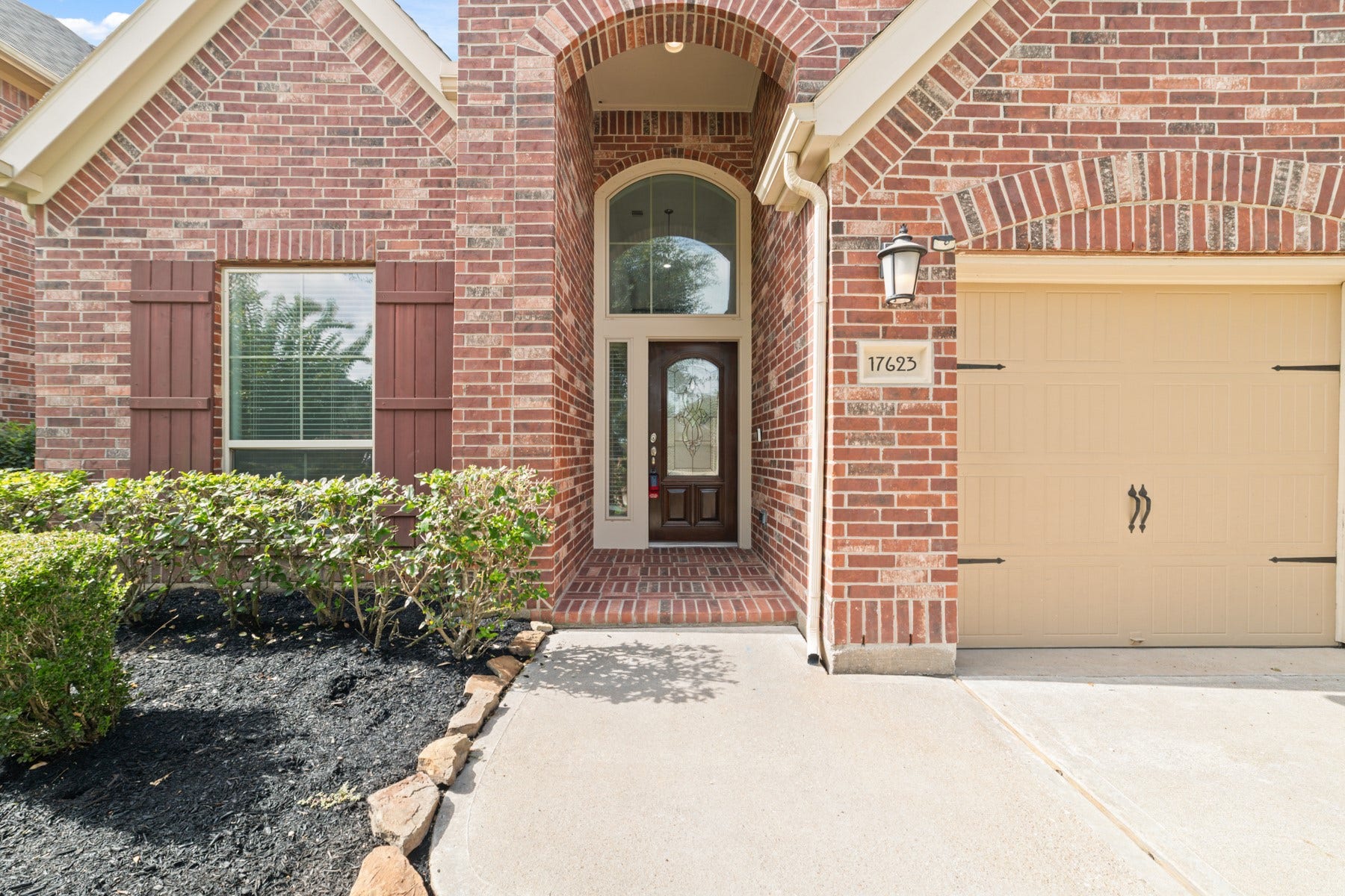 This elegant brickwork and charming wooden door, warmly welcomes you home.