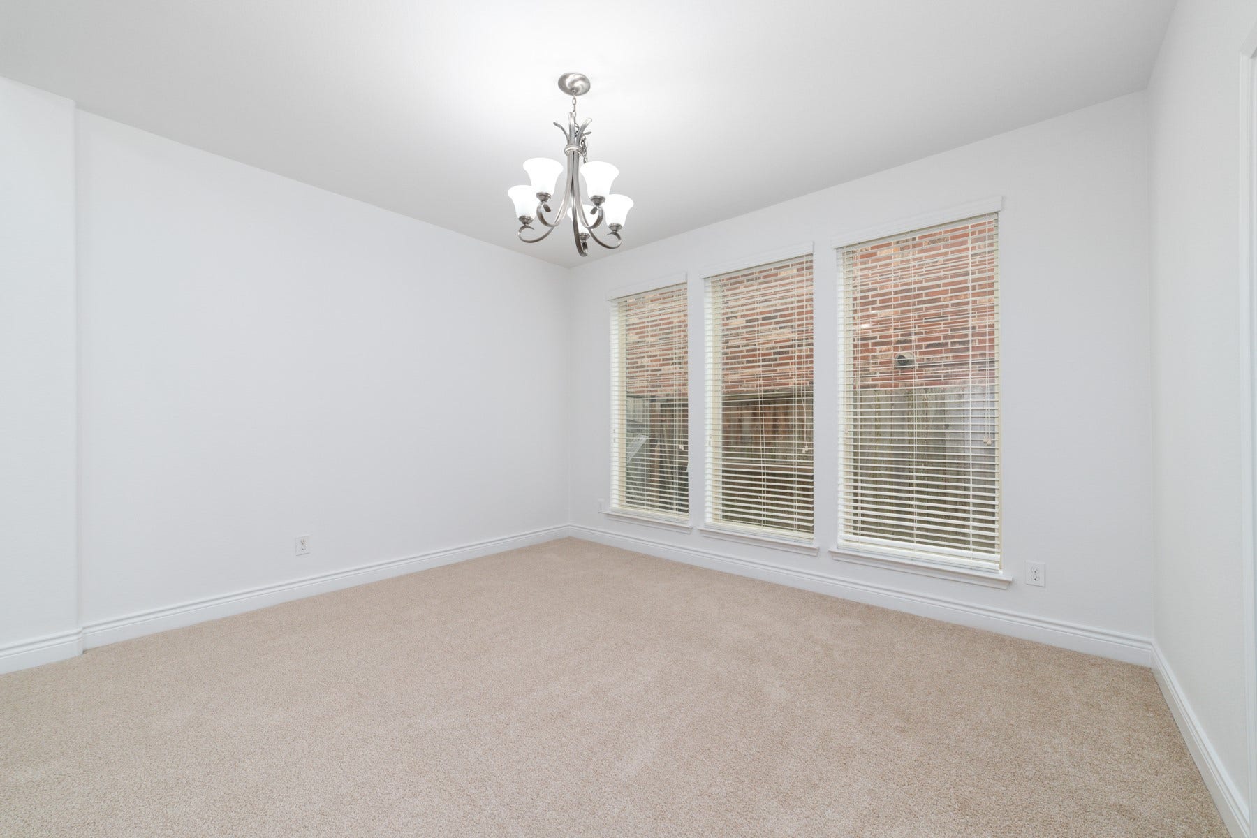 This elegant dining area seamlessly connects to a spacious kitchen.