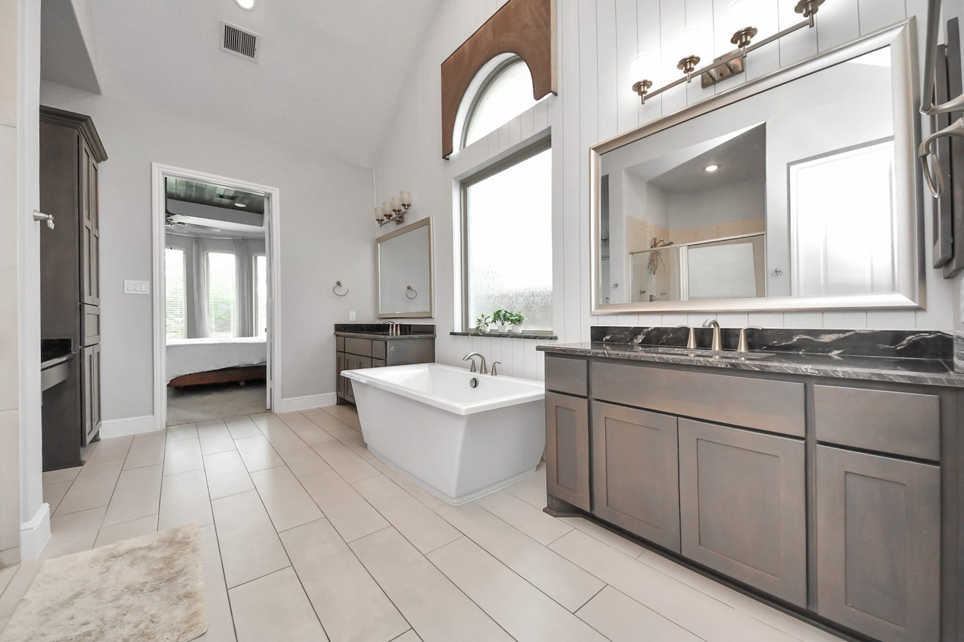 10611 Sawmill Park Drive, Missouri City, TX 77459 Primary Bathroom: Spa-inspired bath with dual vanities, freestanding soaking tub, and designer finishes.