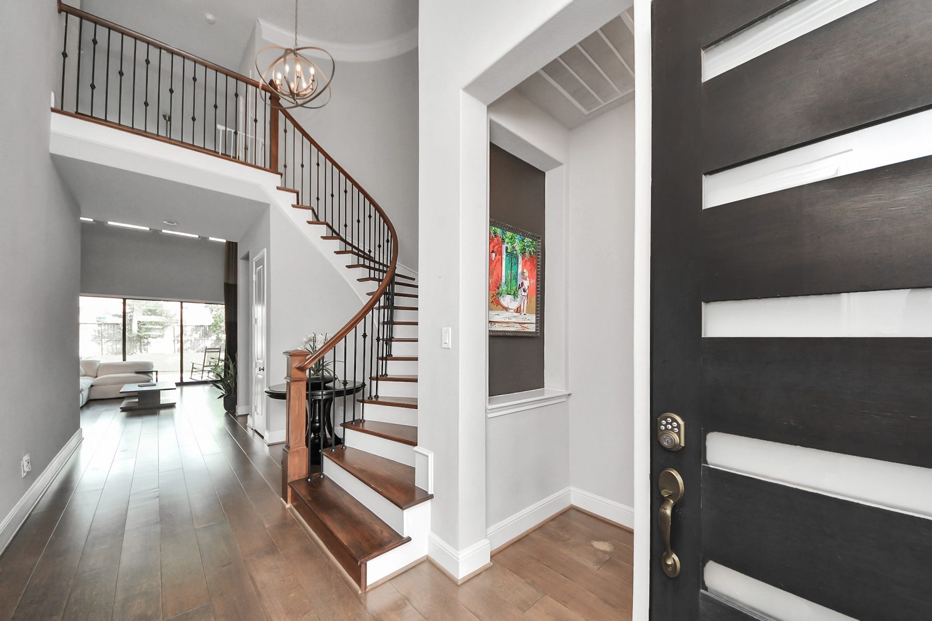 10611 Sawmill Park Drive, Missouri City, TX 77459 Grand Entry: Impressive foyer showcasing modern double doors, soaring ceilings, and curved staircase.