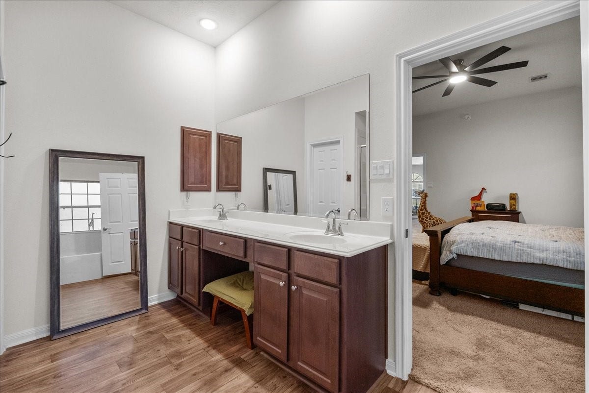 2111 Gilbert Road, Dickinson, TX 77539 The private en-suite bath features a walk-in shower, soaking tub, double sinks and a walk-in closet