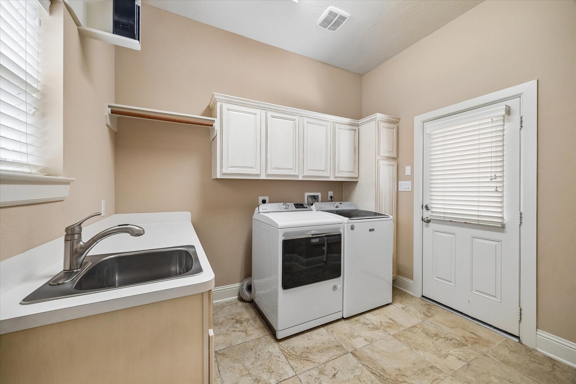 14407 Tivoli Drive, Houston, TX 77077 The laundry room with sink and plenty of storage