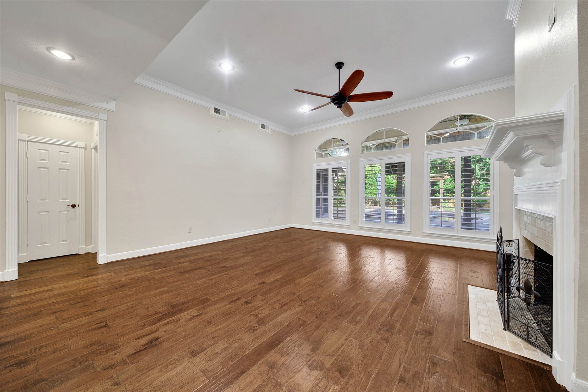 5814 Woodland Creek Drive, Kingwood, TX 77345 This outstanding living room showcases the beautiful hardwood floors. High ceilings, large windows overlooking the patio and pool, plantation shutters, recessed lighting and gaslog fireplace make this a comfortable place to relax or entertain.
