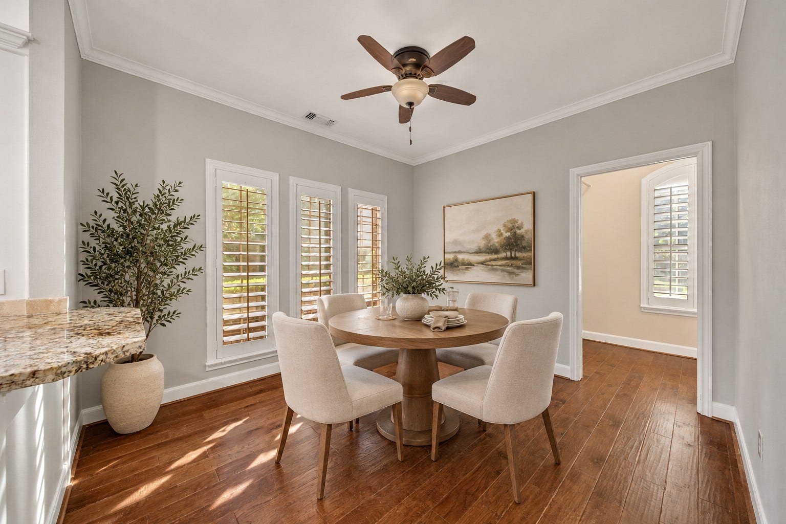 5814 Woodland Creek Drive, Kingwood, TX 77345 Huge breakfast room with adjacent butlers pantry / laundry utility room. Plantation shutters offer an elevated look to this functional space. Photo has been digitally altered using generative ai for virtual staging. Buyer to verify all.