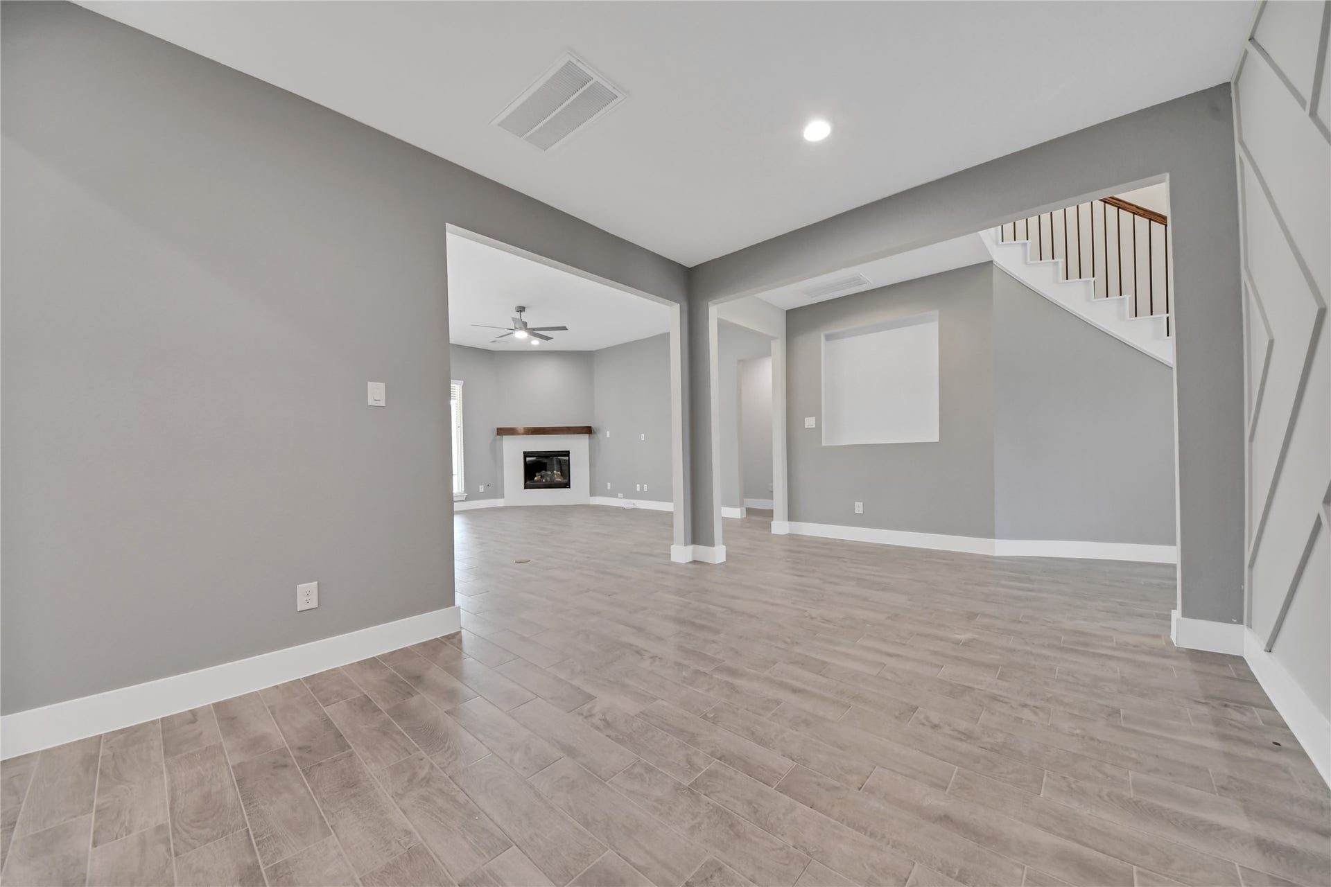 23619 Iris Field Court, Katy, TX 77493 Spacious dining room with an open layout, wood-look tile flooring, and easy flow into the main living areaperfect for everyday dining and entertaining.